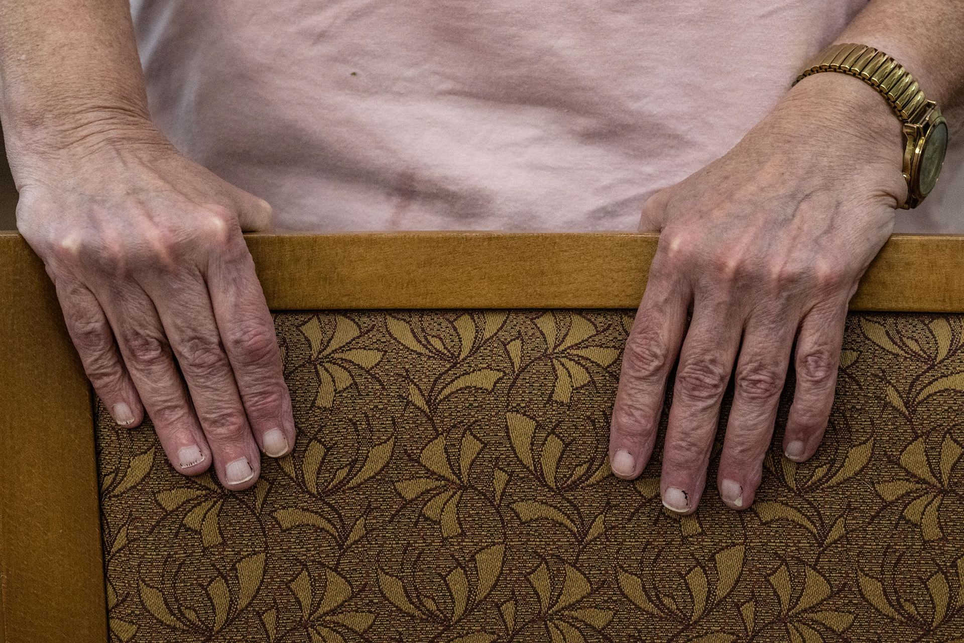 Cathy holds on to a chair to keep her balance during the exercise class with Barb on Tuesday, Nov. 4, 2025, in Syracuse, N.Y.