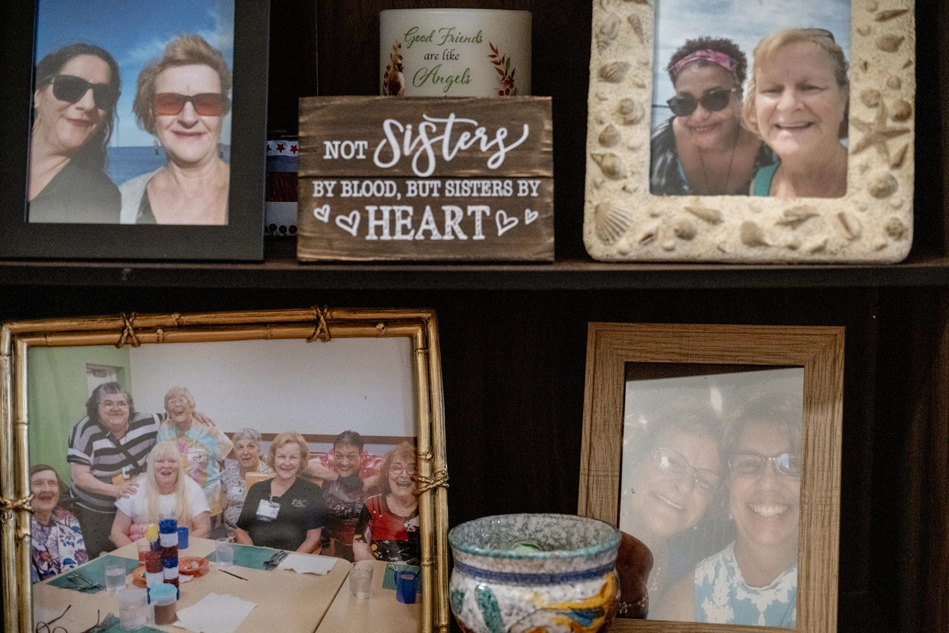 Photo frames in Barb’s living room display important people in her life and moments from her volunteer work with senior programs back in Connecticut on Monday, Nov. 3, 2025, in Syracuse, N.Y. “We are not sisters by blood, but we are sisters at heart,” she said.