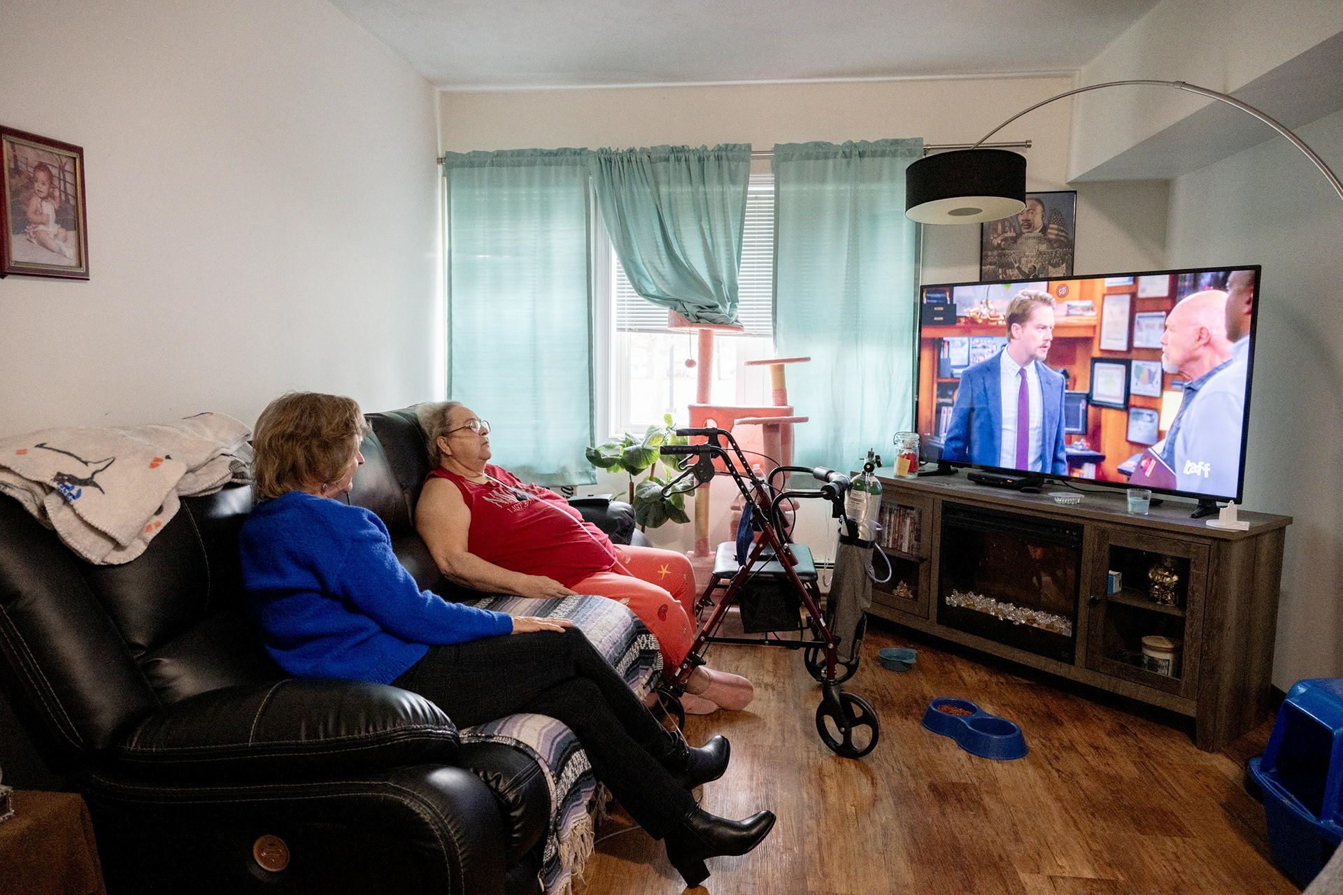 Senior Companion Program volunteer Barbara Genese spends time at home with her client, Brenda Nichols, watching TV after Brenda’s dialysis on Monday, Nov. 3, 2025, in Syracuse, N.Y. Barbara has been Brenda’s companion for the past two years.