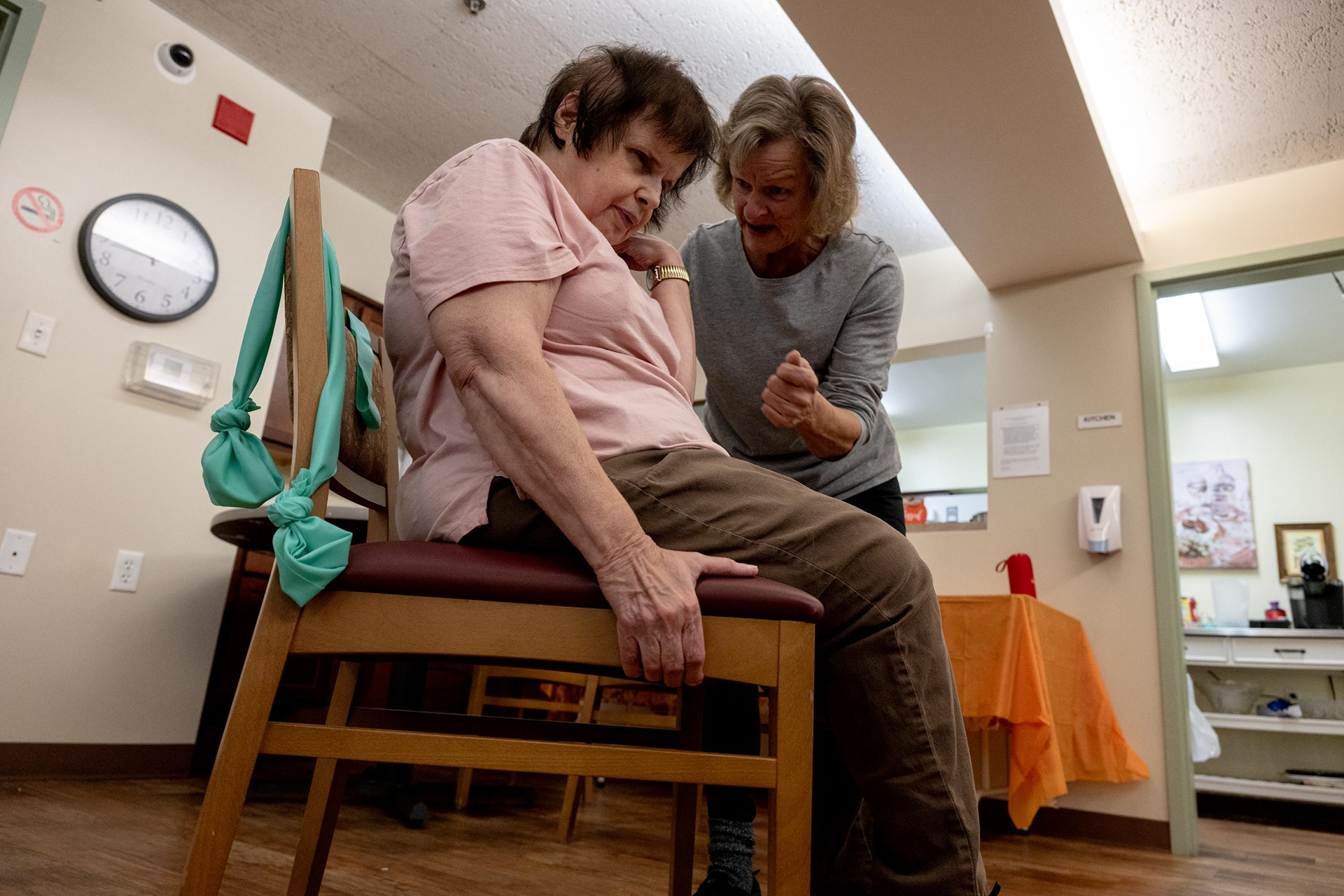 Barb explains next activities to Cathy who has vision impairment during the exercise class on Tuesday, Nov. 4, 2025, in Syracuse, N.Y. Cathy, who is blind, is eager to stay active. 