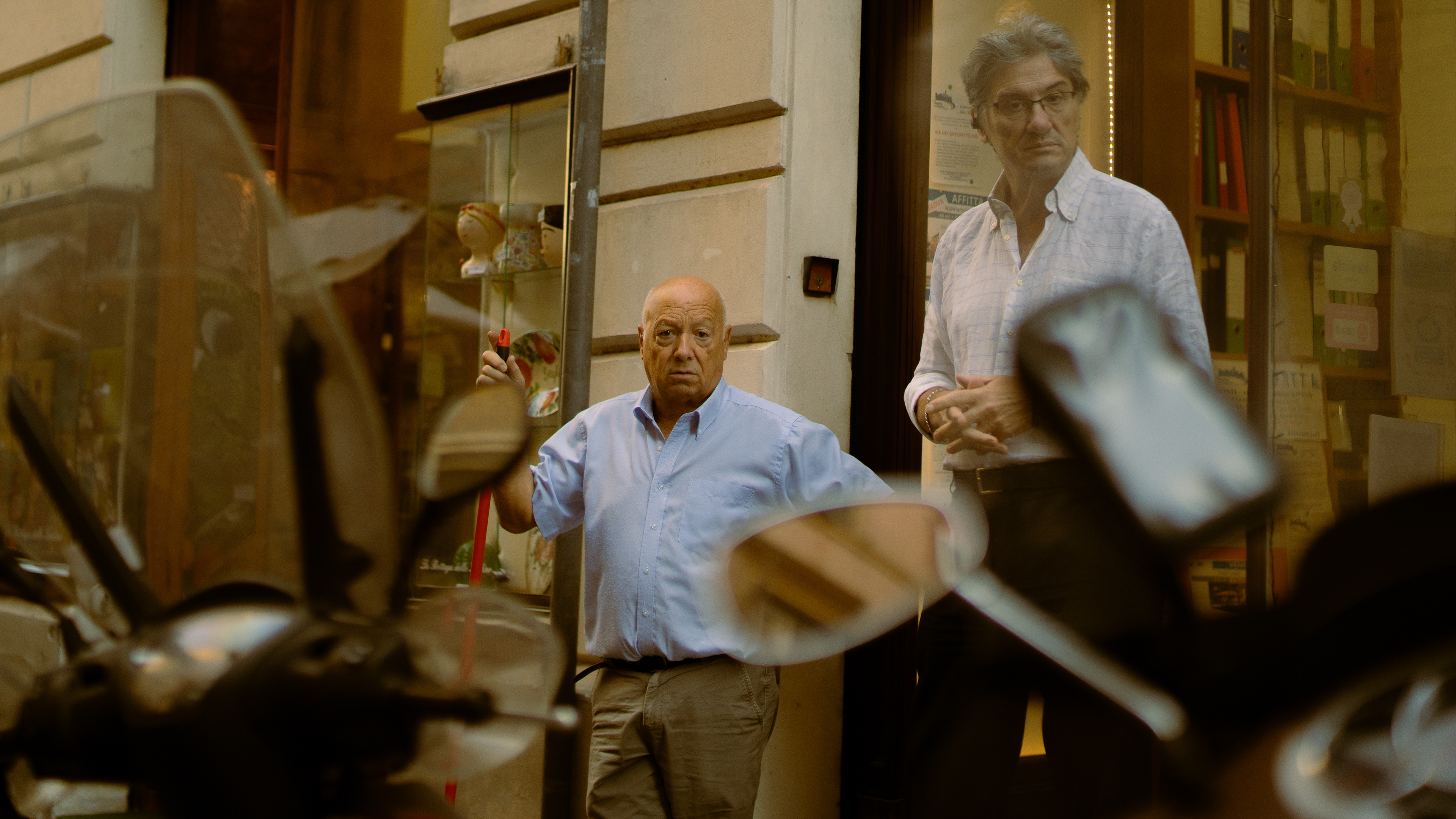 Hidden behind the scooters.