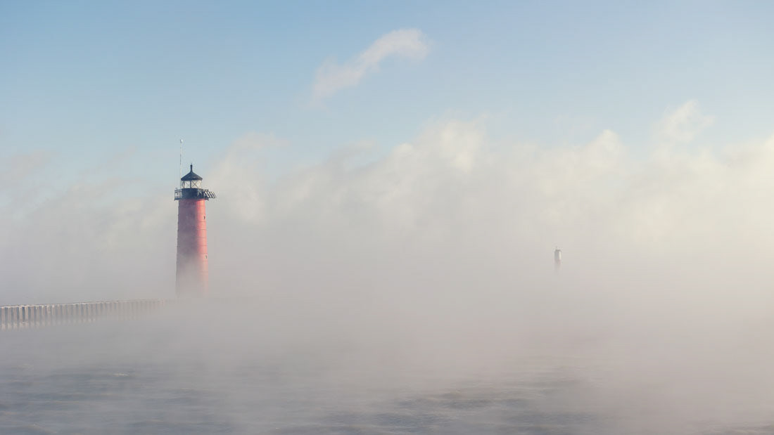 Kenosha North Pierhead Lighthouse obscured by foggy vapor from Lake Michigan.