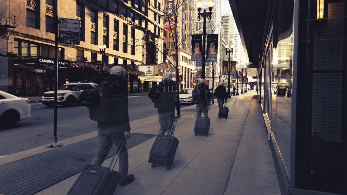 Chicagohenge image of a man walking downtown pulling a suitcase behind him. Fine art photo.