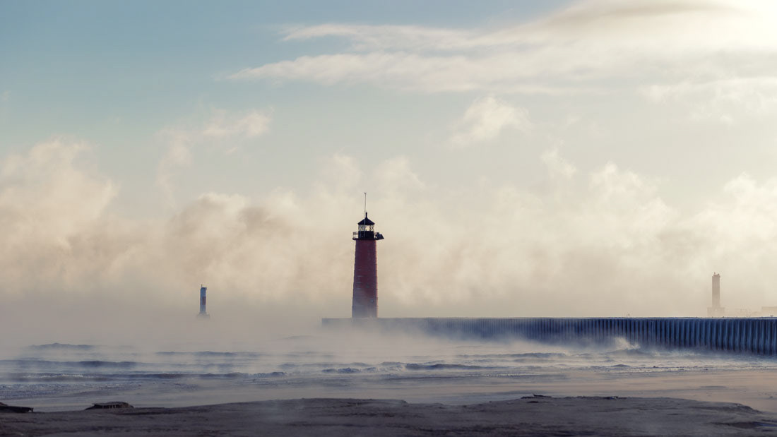 Kenosha North Pierhead Lighthouse obscured by foggy vapor from Lake Michigan.