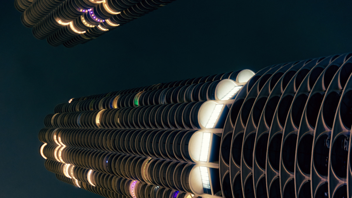 Marina towers seen from below at night on the Chicago River.