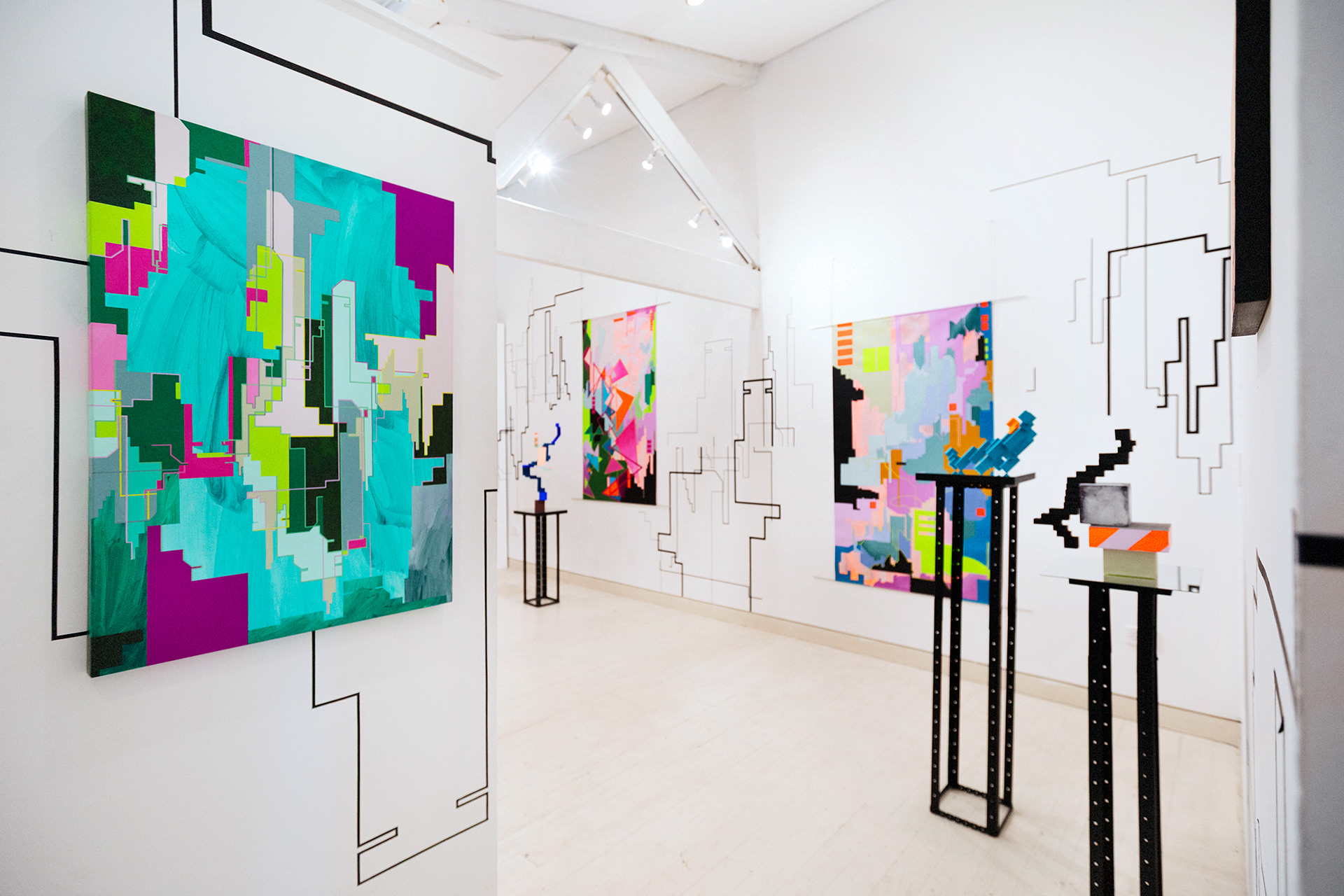 Installation with abstract cityscape wall drawing and colourful abstracted cityscape paintings and sculptures by merryn trevethan
