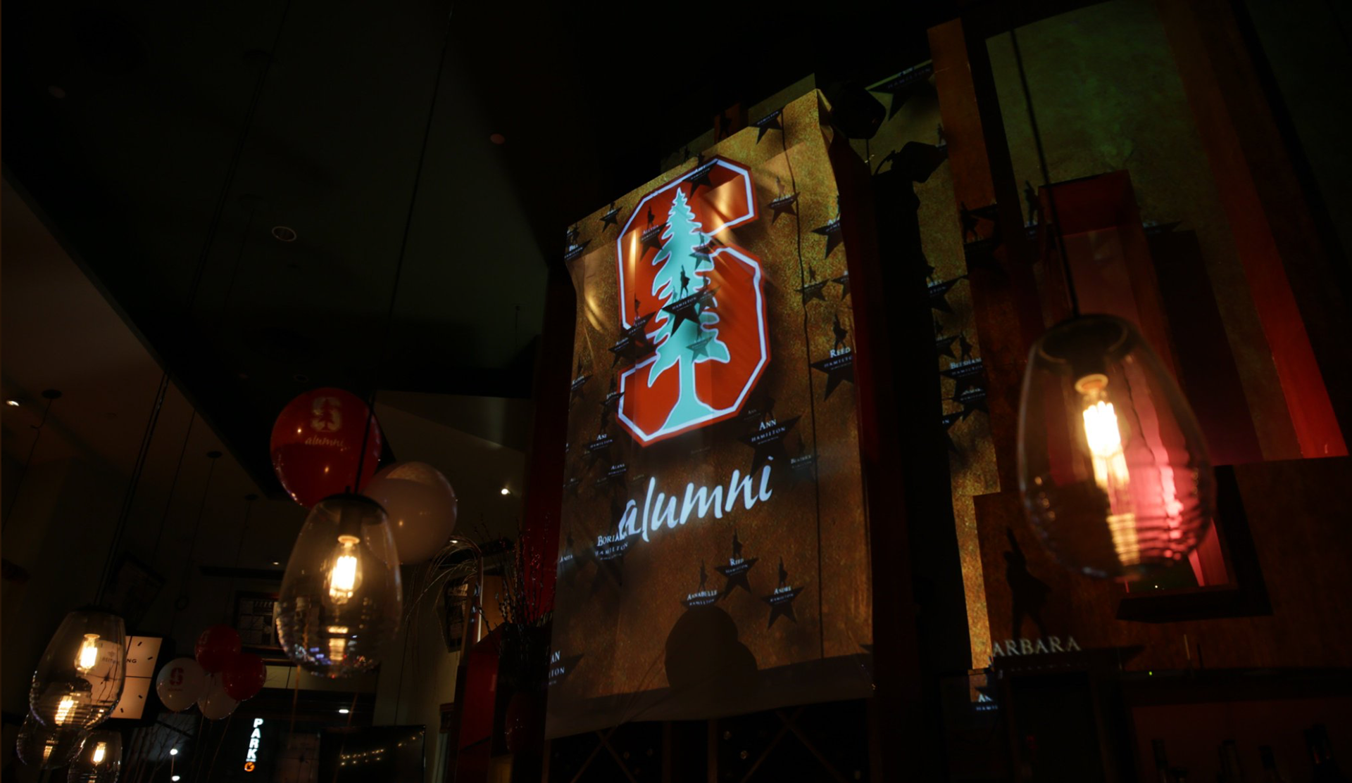 Ambient lighting and branded projection visuals at the Hamilton x Stanford Broadway reception, designed for an immersive VIP guest experience.