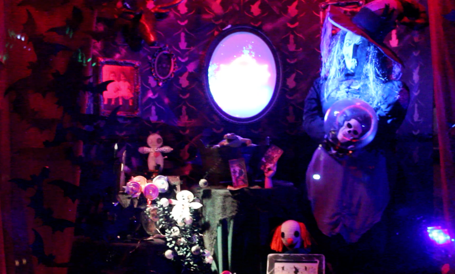 AI-generated Halloween projection mapping on a two-story house featuring ghostly visuals, fog, and Gothic architectural overlays in cinematic blue lighting.