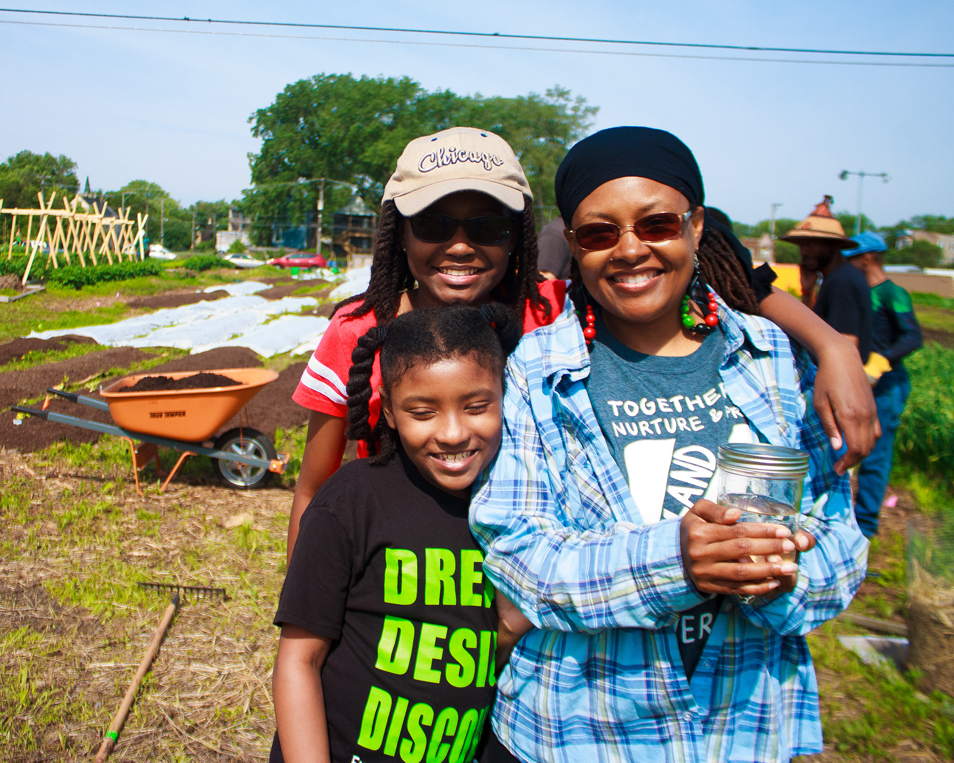 Safia (owner of Your Bountiful Harvest Family Farm) and her daughters pose with the libation for the land ceremony. Chicago, IL ‘19