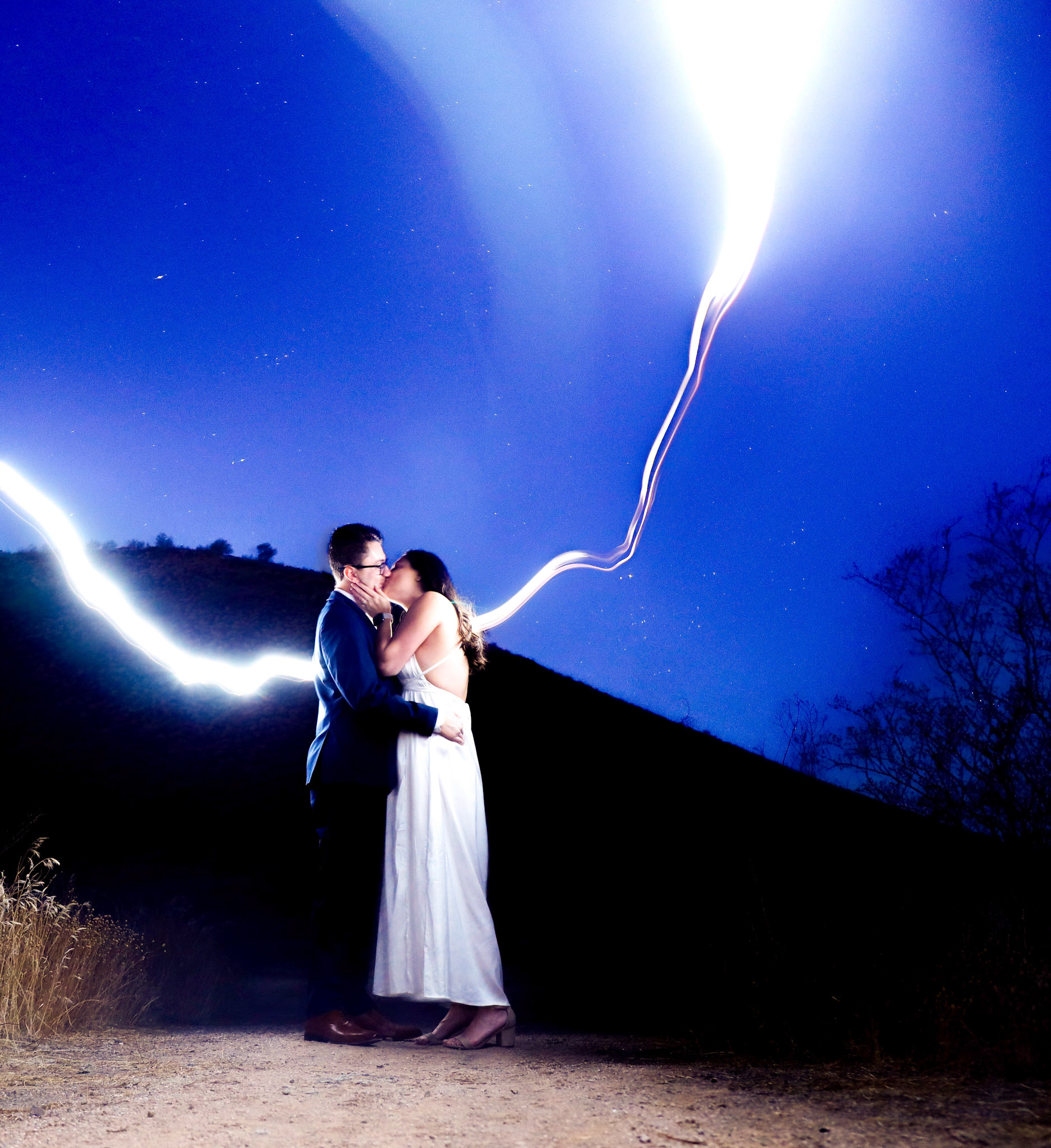 Ethan Sumner and Amber Kitay seal a kiss at dawn in the North Scottsdale, Ariz. desert during their engagement photo shoot on Nov. 24, 2023.