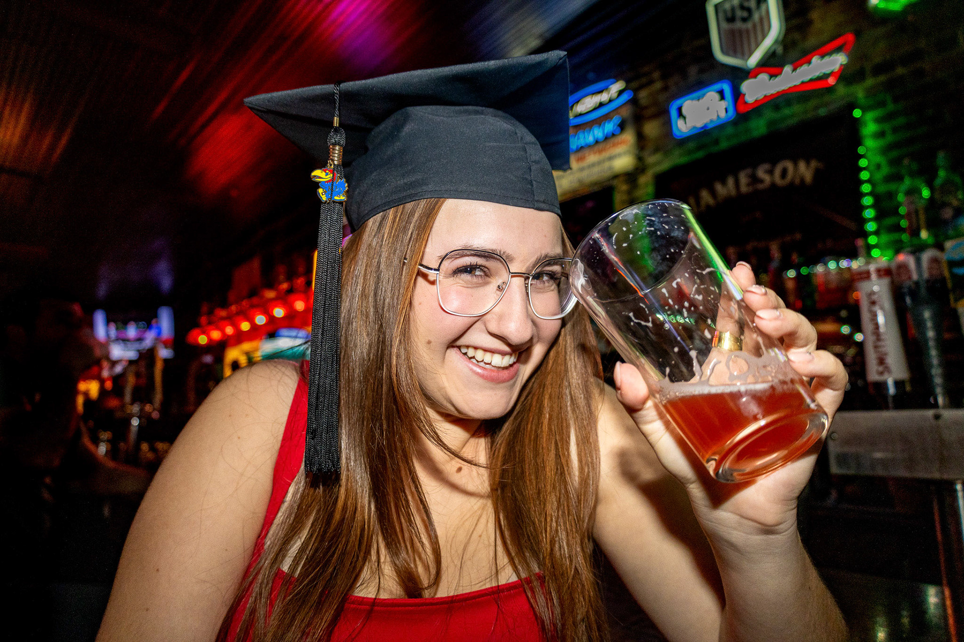 New graduate Rose Coggan enjoys her cherry cider at Red Lyon Tavern in Lawrence, Kan., on April 12, 2024. Coggan finished her time at the University of Kansas with a Masters in Accounting.
