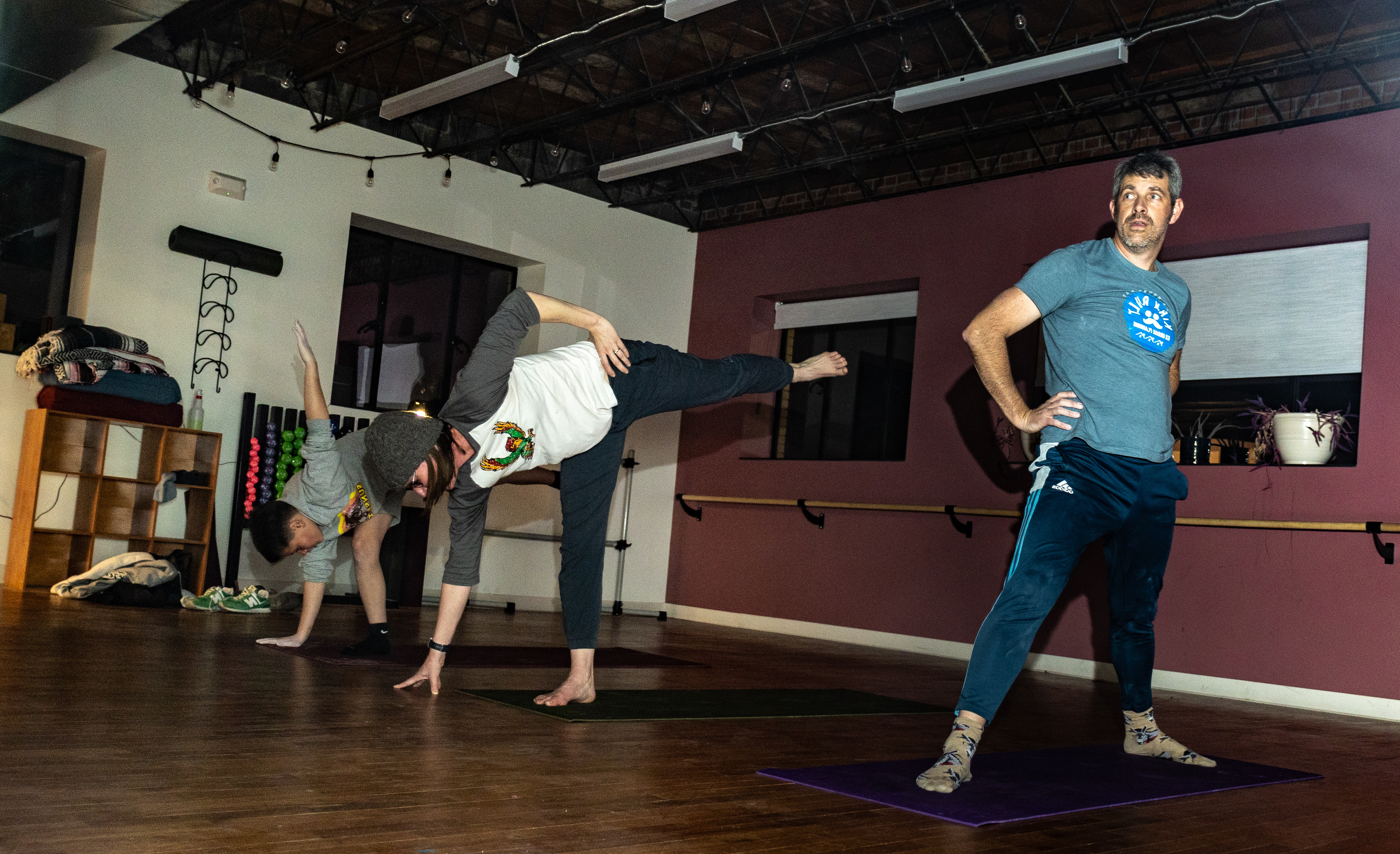 Meg Lyles, 48, middle, and Will practice a standing balance pose while Ward gets ready for the position at Climb Lawrence on March 2. Meg, Ward’s wife, is in the process of getting her 200-hour-yoga certification and instructs her family for fun. Ward enjoys taking yoga classes regularly in order to stay flexible and practice meditation. This was Will's first attempt.