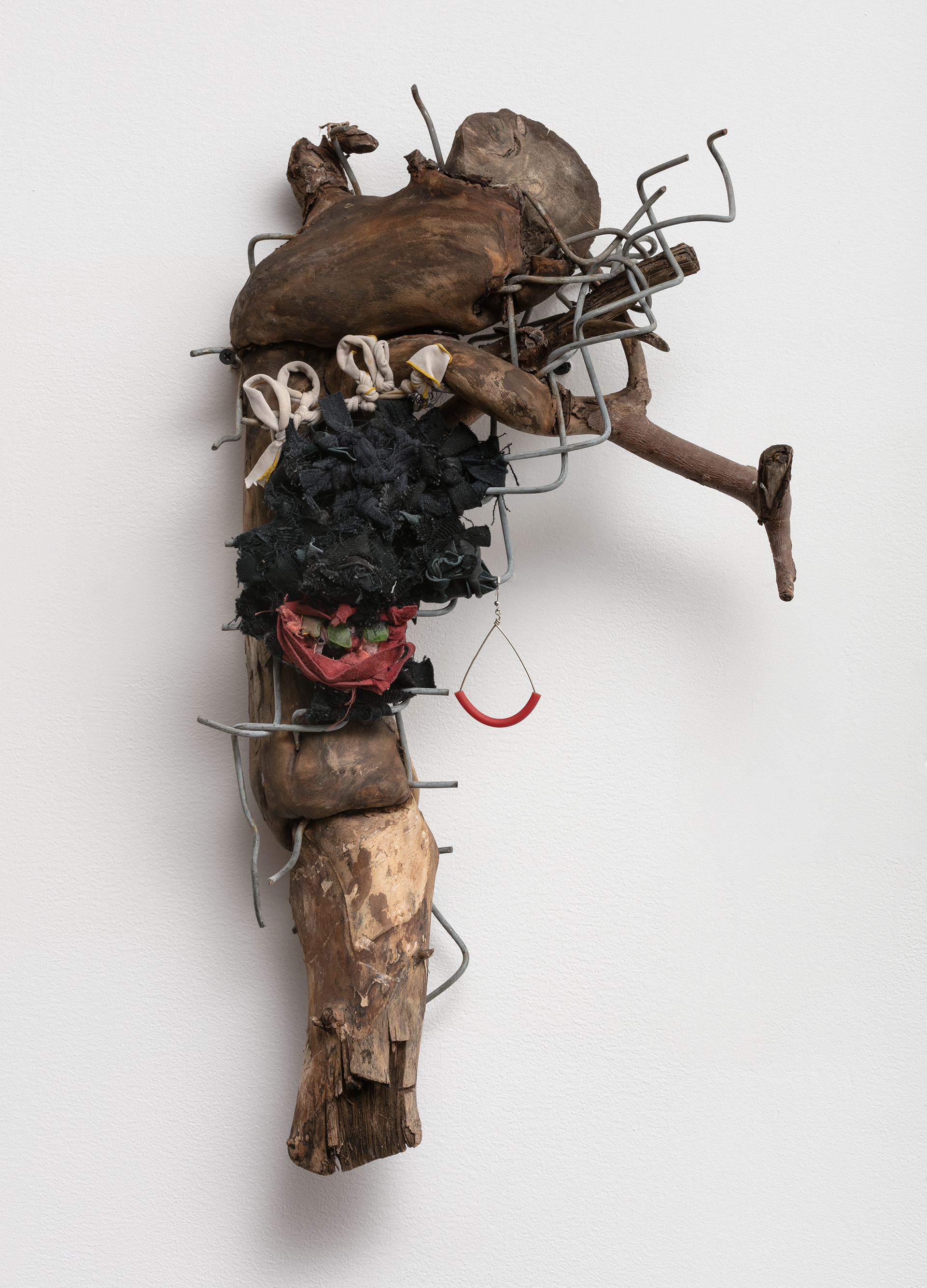 Knotty, 2018. Wood, fence, leather, fabric, sea glass, tar, earring. 18 x 12 x 6 in (45.7 x 30.5 x 15.2 cm).