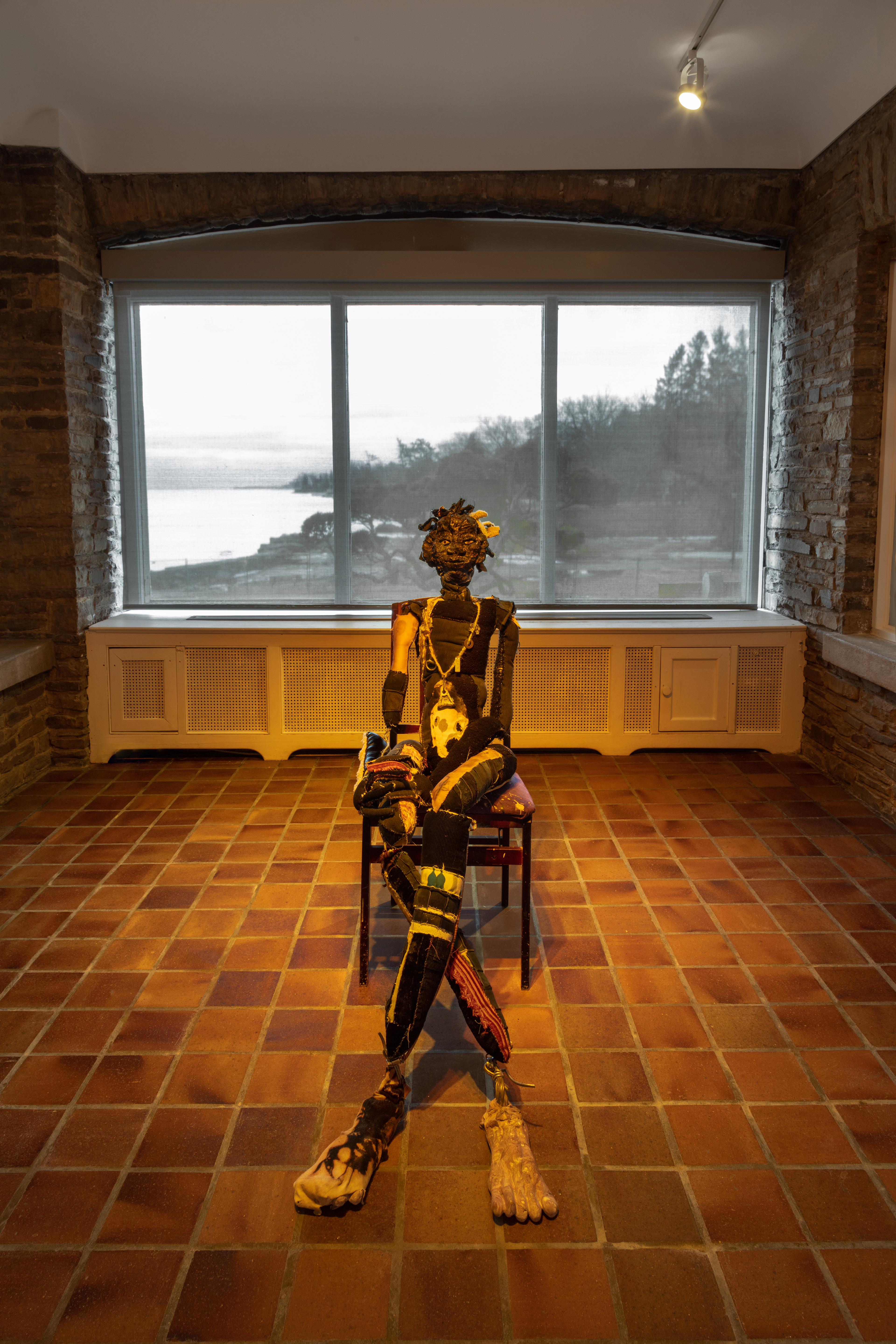 Sparkle and Sparkle’s map home, 2018. Recycled fabrics, rawhide, leather, carved plaster, acrylic paint, wire, hardware, jute, found objects, stones, found photographs, chair. Sparkle: 44 x 18 x 24 in (111.8 x 45.7 x 61 cm) Sparkle’s map home: 72 x 51 in (182.9 x 129.5 cm).