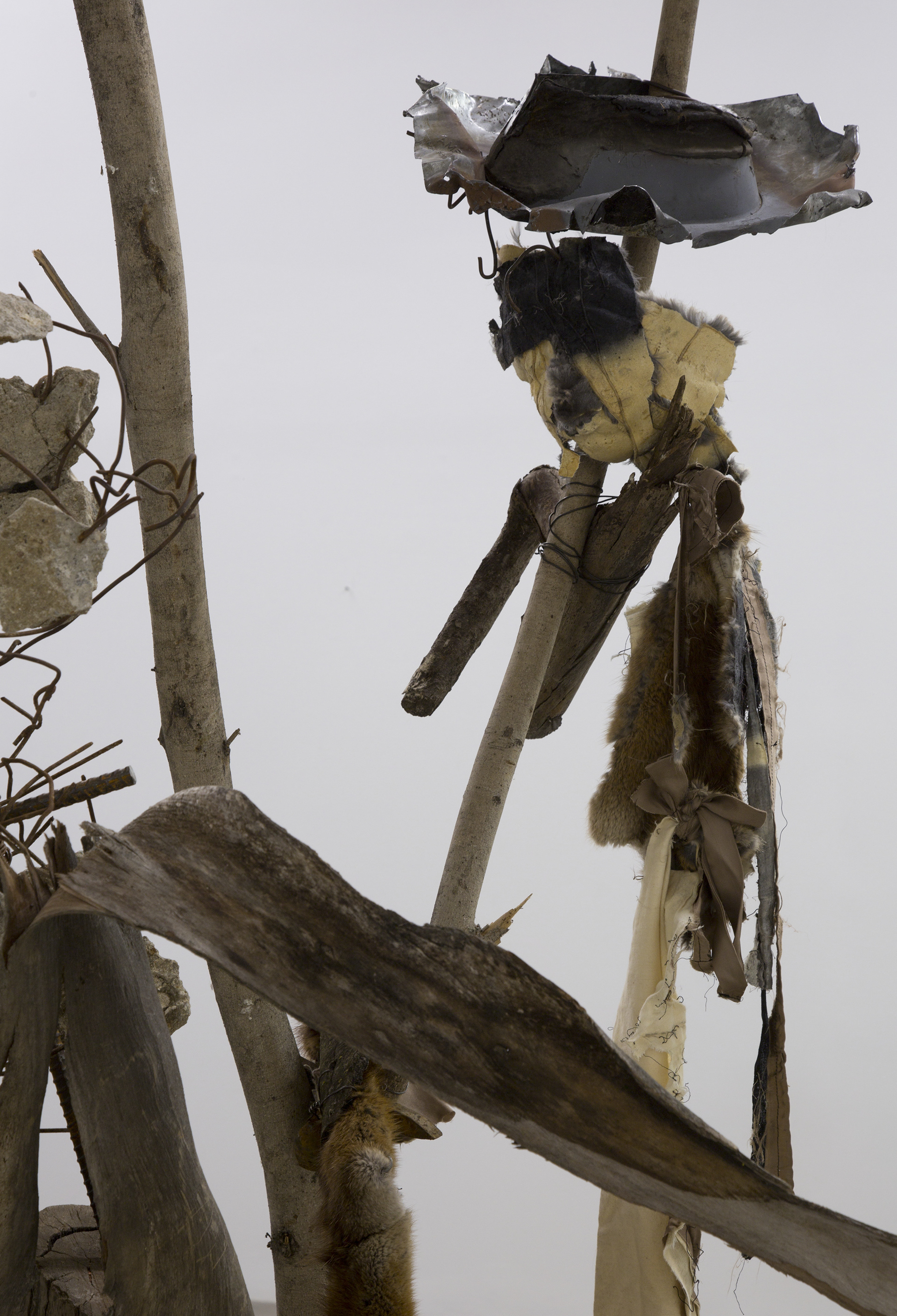 Untitled (romantic dancing), 2017. Tree branches, concrete, rebar, scrap metal, cinderblock, fur, cloth.