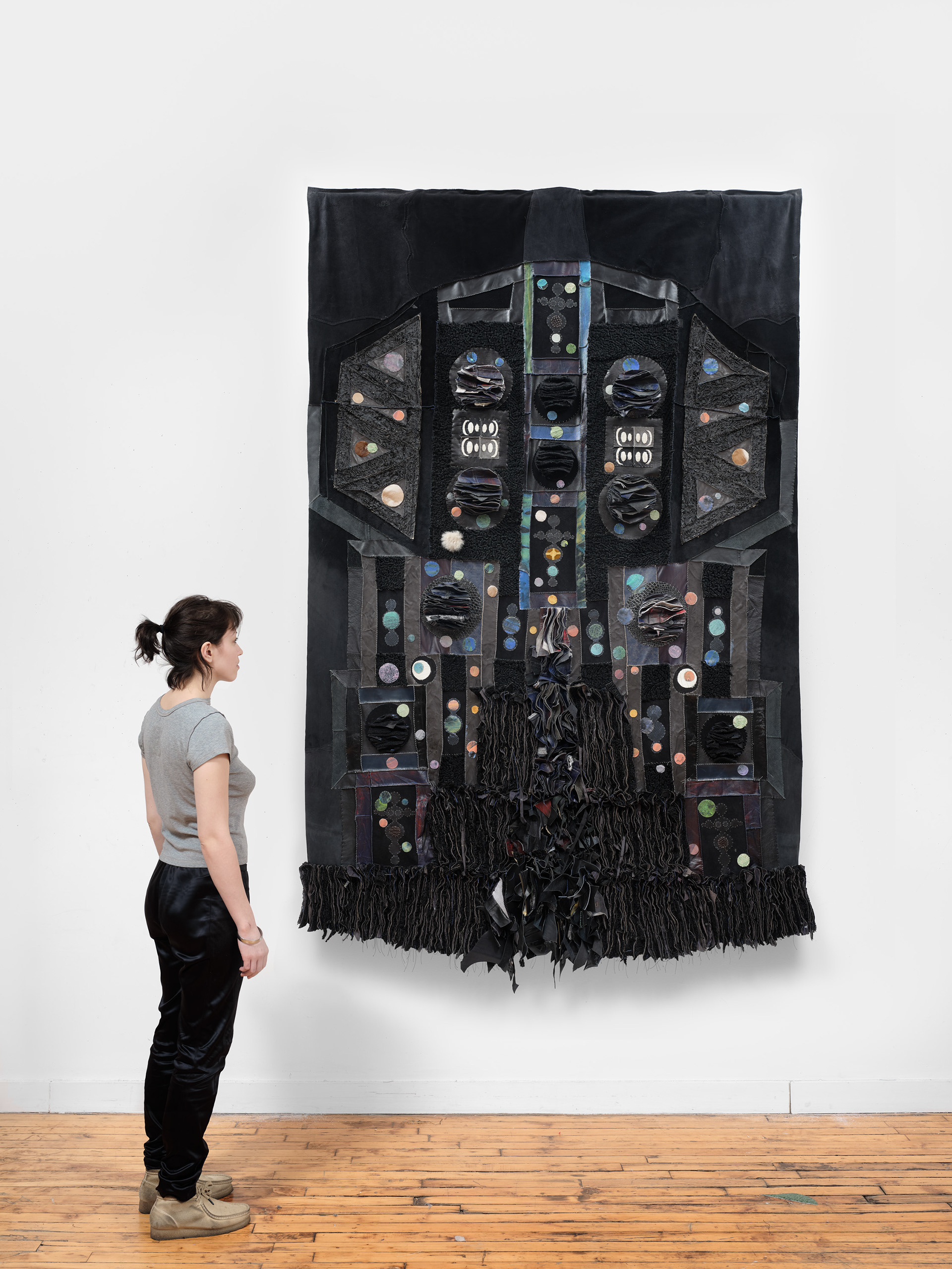 Belly of the Abyss, 2022 Repurposed leather, shearling, vinyl, suede, fur, acrylic paint, PVA glue, leather primer, wooden dowel, steel brackets. 98 inches x 62 inches x 10 inches.