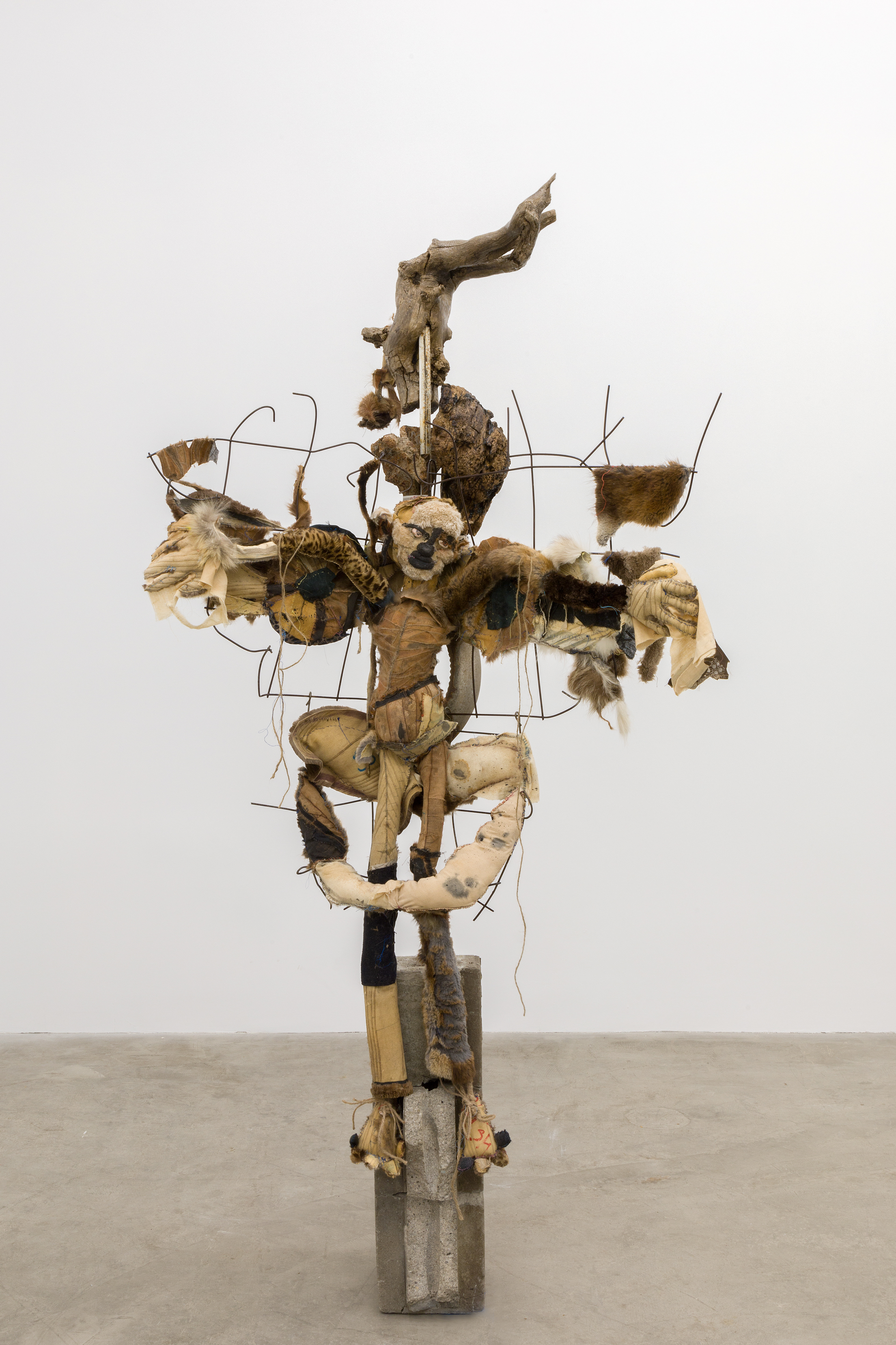 Three angels waiting, 2018. Concrete, rebar, concrete mesh, hand sewn furs, leathers and fabrics, cotton batting, stones, pipes, driftwood, dried flowers, hardware. 76 x 38 x 24 inches (193.04 x 96.52 x 60.96 cm).