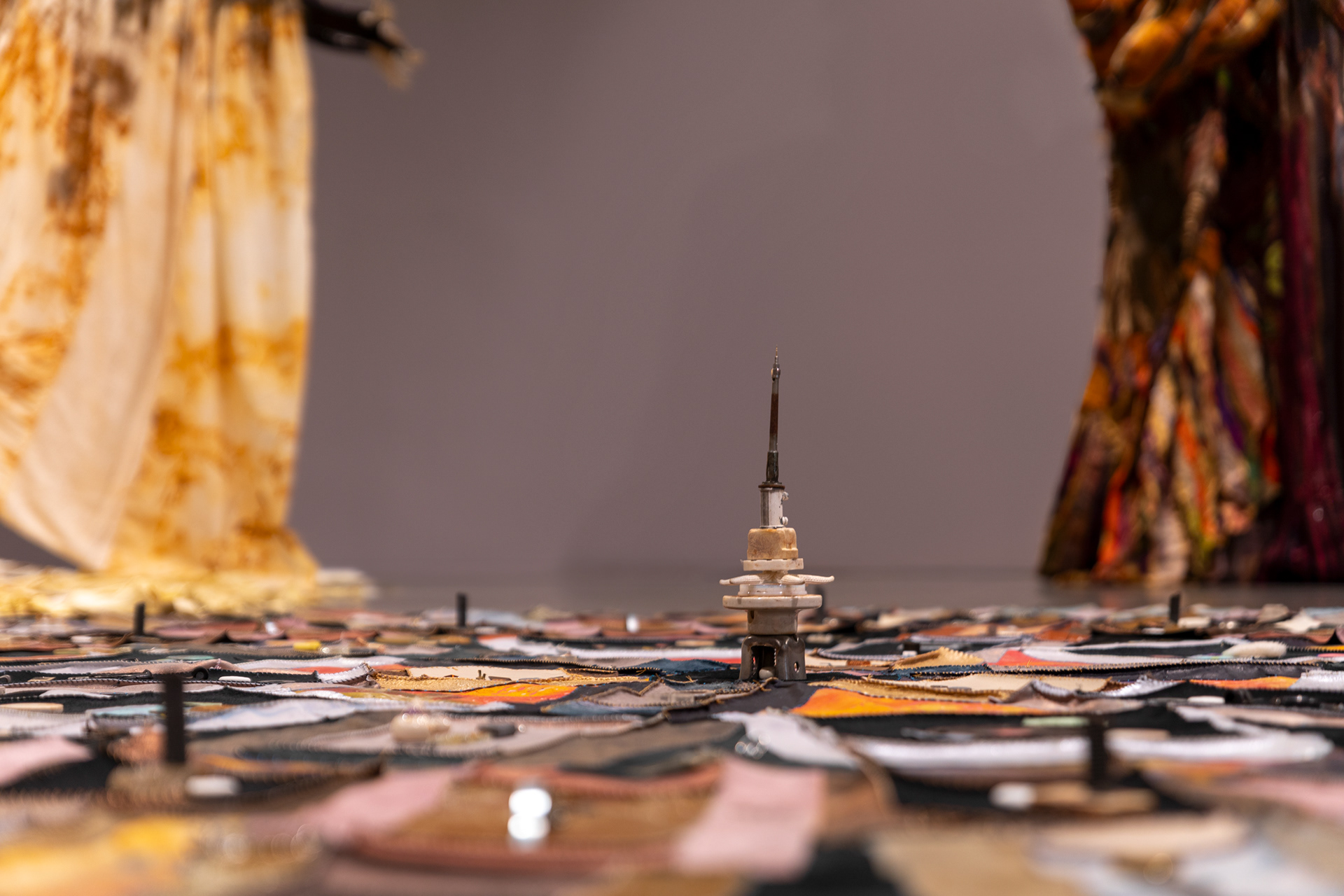 (detail) The Last Transmission, 2024, Repurposed leather and suede; cotton canvas; acrylic paint and finisher; leather, fabric, and natural dyes; assorted found metal, wood, ceramic, and glass objects; wire; beads; seashells; coated nylon thread; and coated cotton thread, 8H x 182 inch diameter