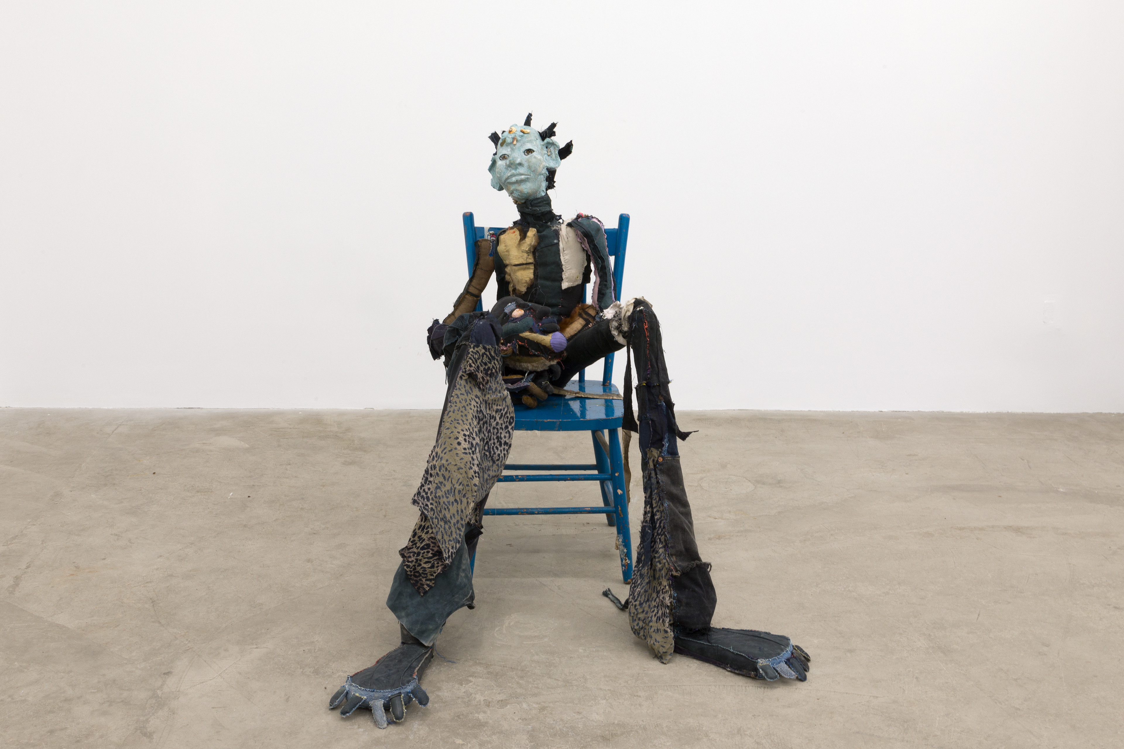 Dainty the mermaid, 2018. Hand sewn fabrics, furs and leathers, hand carved plaster, acrylic paint, copper pipes, polyester stuffing, wire, concrete, seashells, stones and wooden chair. 40 x 29 x 40 in (101.6 x 73.7 x 101.6 cm).