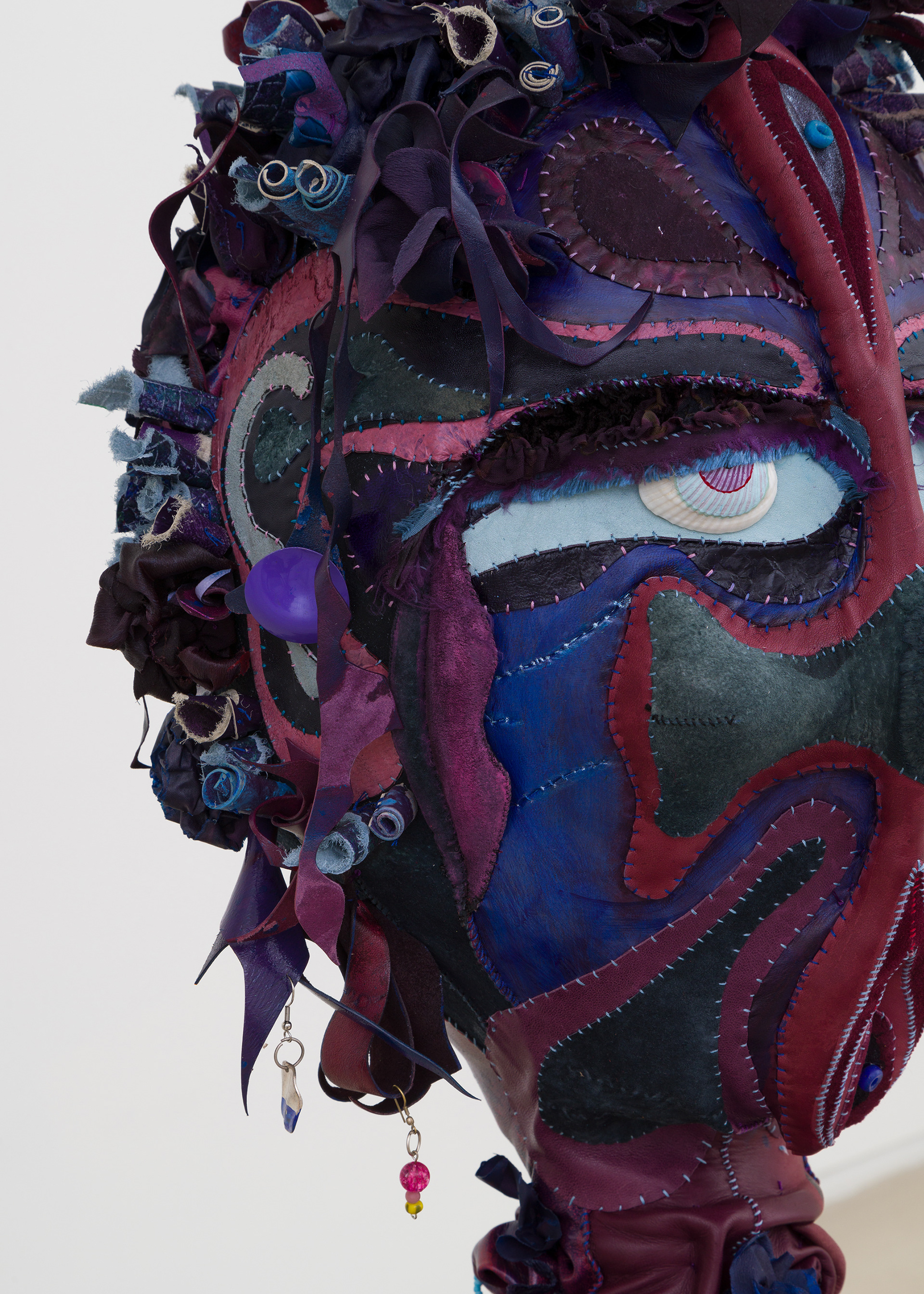(detail) Venus in Leo, 2023, Steel, wood, enamel paint, acrylic paint, leather dye and finisher, repurposed leather and sueder, repurposed fabric, found jewelry, clam shells and coated nylon thread, 68H x 18 x 18 inches