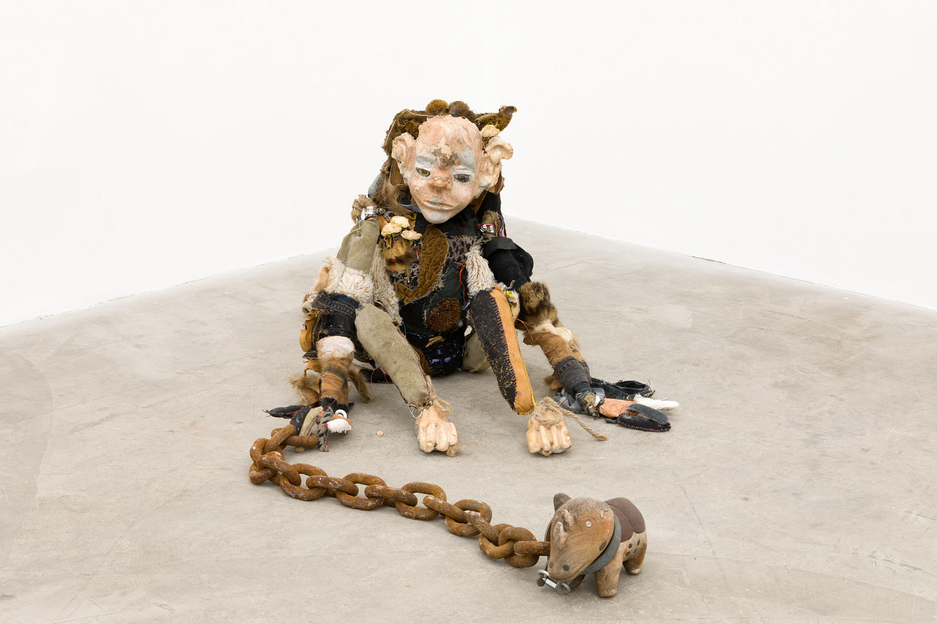 Boom bang (shiny girl). 2018. Hand sewn fabrics, furs and leathers, hand carved plaster, acrylic paint, wire, stones, jute, hardware, human hair, found toy, leather gloves, wood sculpture, chain, dried flowers. 20 x 16 x 20 in (50.8 x 40.6 x 50.8 cm).Boom bang (shiny girl). 2018. Hand sewn fabrics, furs and leathers, hand carved plaster, acrylic paint, wire, stones, jute, hardware, human hair, found toy, leather gloves, wood sculpture, chain, dried flowers. 20 x 16 x 20 in (50.8 x 40.6 x 50.8 cm).