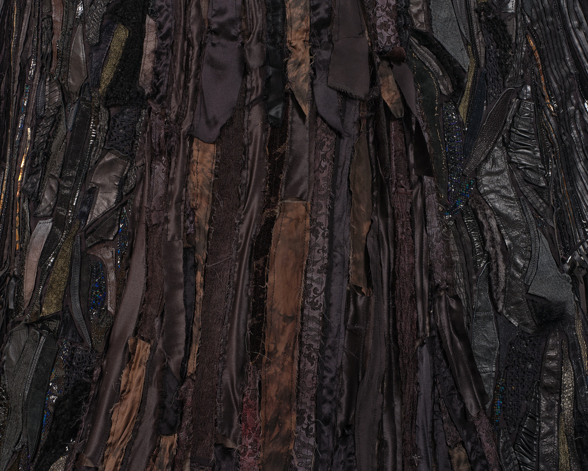 (detail) The Night Woman, 2024, Steel; enamel paint; acrylic paint and finisher; repurposed leather, suede, shearling, fur, shagreen, and assorted fabric; leather, fabric, and natural dyes; cow bone; conch; abalone shell; stones; jute; coated nylon thread; and coated cotton thread, 130H x 137 x 106 inches