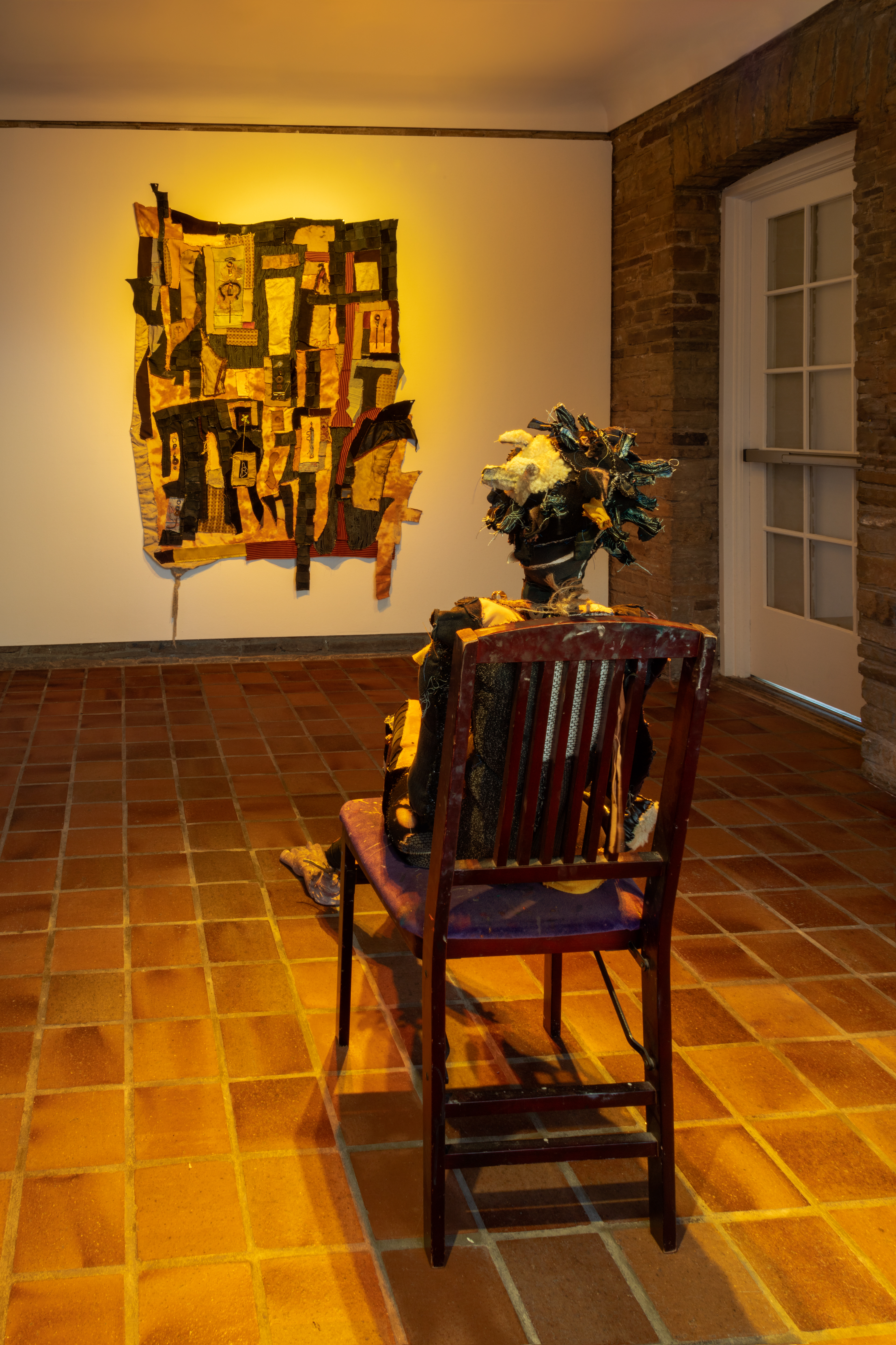 Sparkle and Sparkle’s map home, 2018. Recycled fabrics, rawhide, leather, carved plaster, acrylic paint, wire, hardware, jute, found objects, stones, found photographs, chair. Sparkle: 44 x 18 x 24 in (111.8 x 45.7 x 61 cm) Sparkle’s map home: 72 x 51 in (182.9 x 129.5 cm).