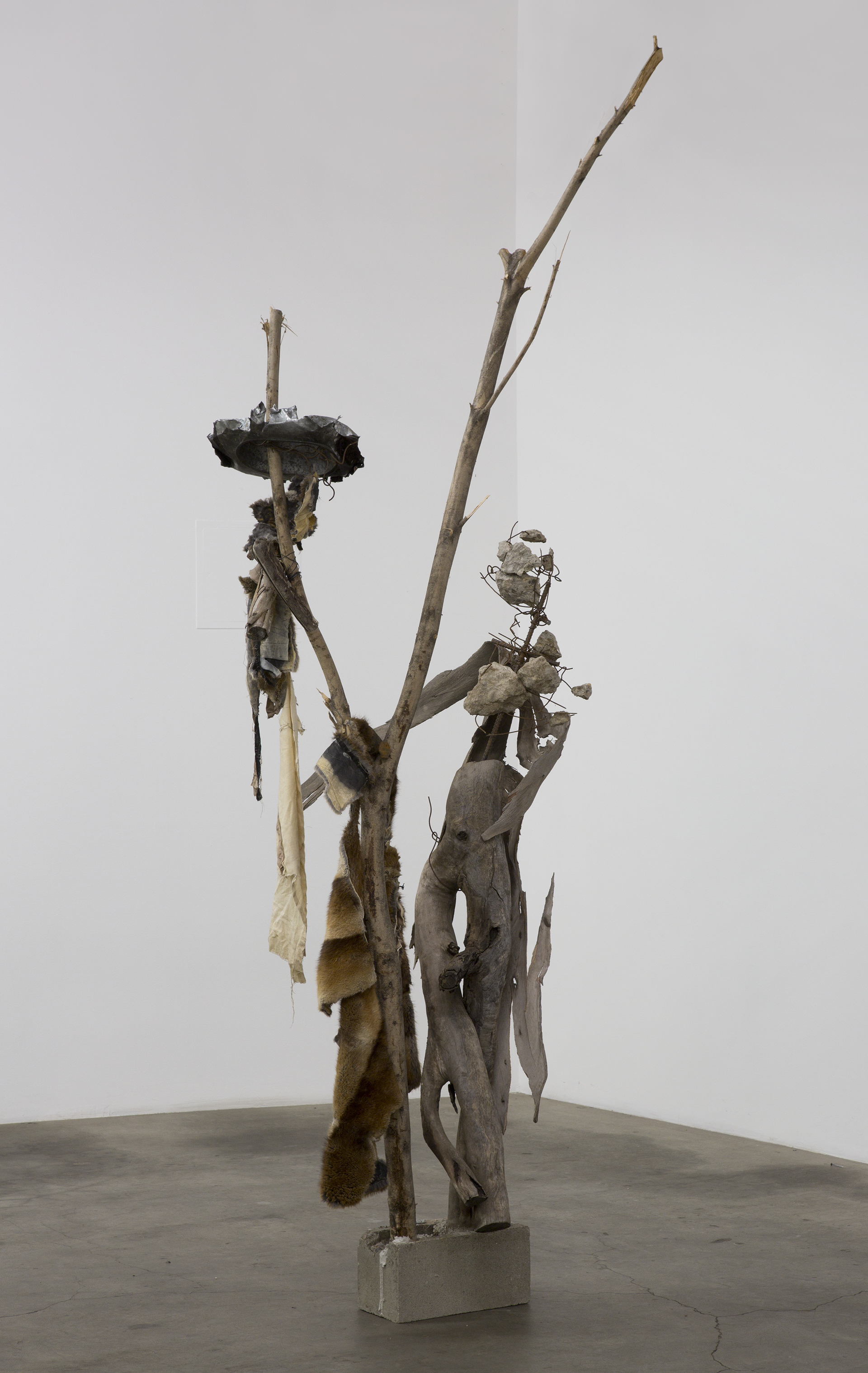 Untitled (romantic dancing), 2017. Tree branches, concrete, rebar, scrap metal, cinderblock, fur, cloth.