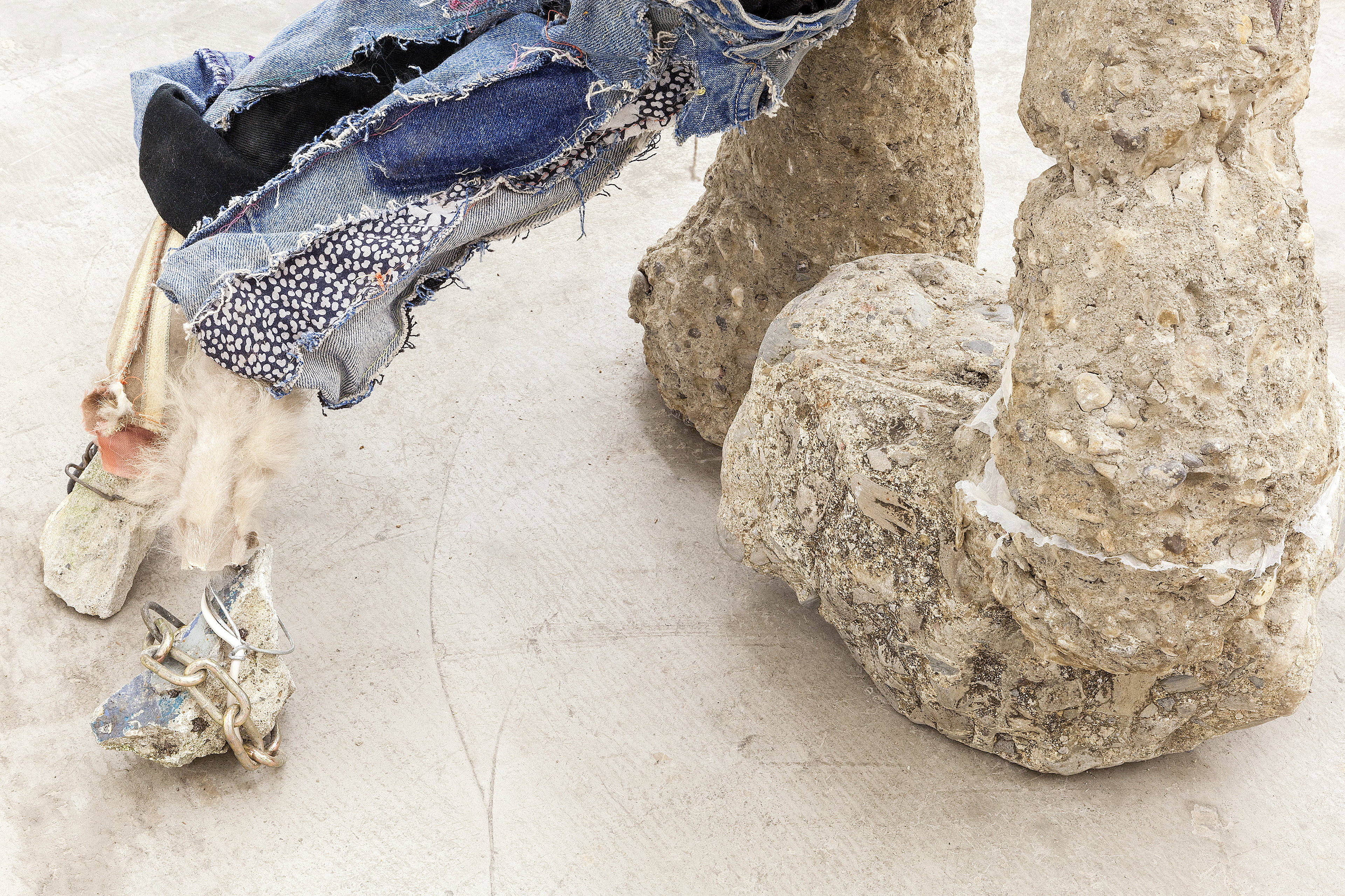 pet rock, 2017. Concrete, rebar, wire, wood, fabric, nails, sea glass, seashells, plaster, acrylic paint, stones, chain, leather, fur. 48 x 29 x 19 inches (121.92 x 73.66 x 48.26 cm).