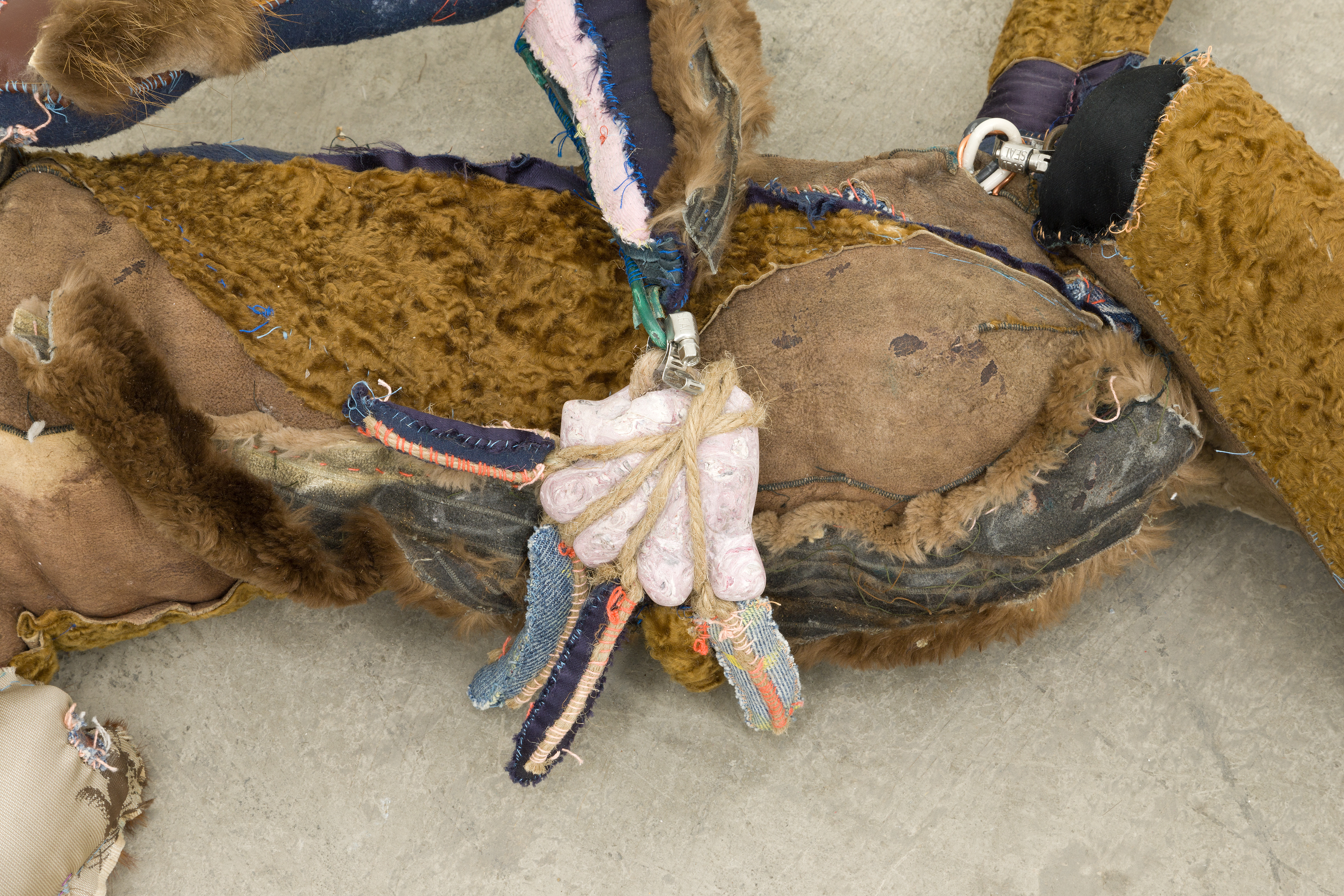 Earnest Lewis King 2017-2018. Hand carved plaster, acrylic paint, hand sewn fabric, leather, fur, jute, paint can, wire, hardware, stones, seashells, chalk pastel, human hair, cotton batting, polyester bating. 10 x 70 x 18 in (25.4 x 177.8 x 45.7 cm).