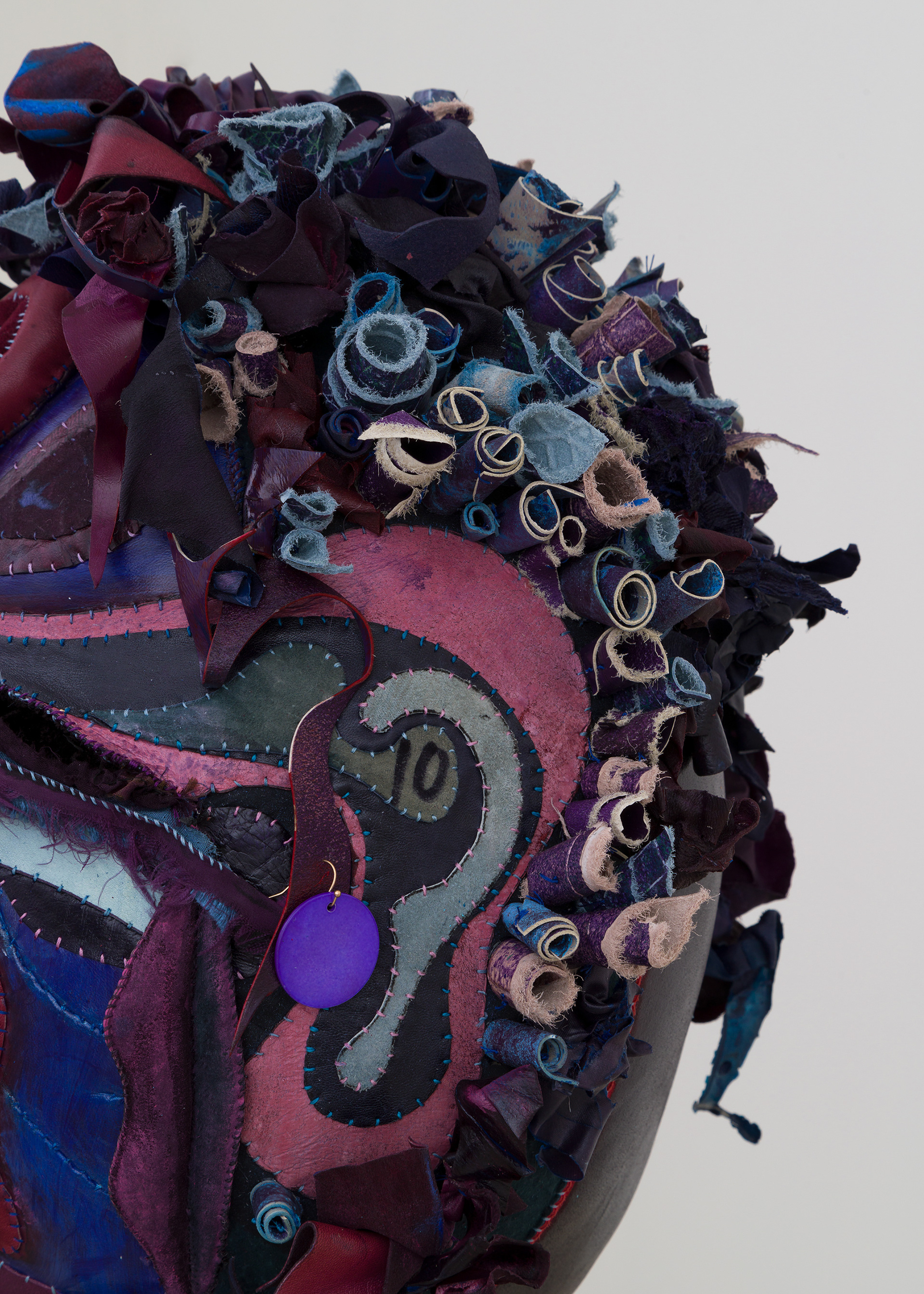 (detail) Venus in Leo, 2023, Steel, wood, enamel paint, acrylic paint, leather dye and finisher, repurposed leather and sueder, repurposed fabric, found jewelry, clam shells and coated nylon thread, 68H x 18 x 18 inches