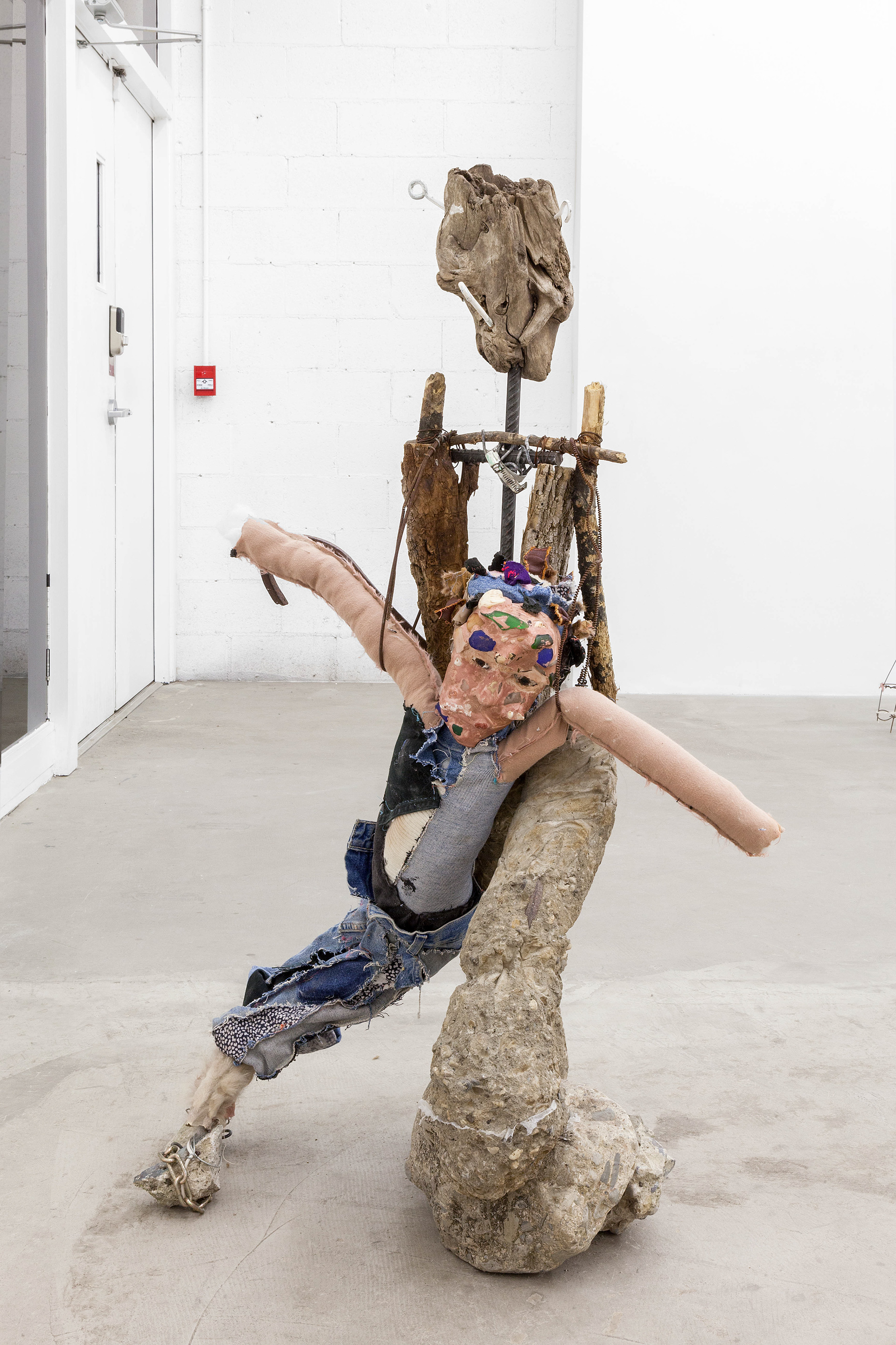 pet rock, 2017. Concrete, rebar, wire, wood, fabric, nails, sea glass, seashells, plaster, acrylic paint, stones, chain, leather, fur. 48 x 29 x 19 inches (121.92 x 73.66 x 48.26 cm).