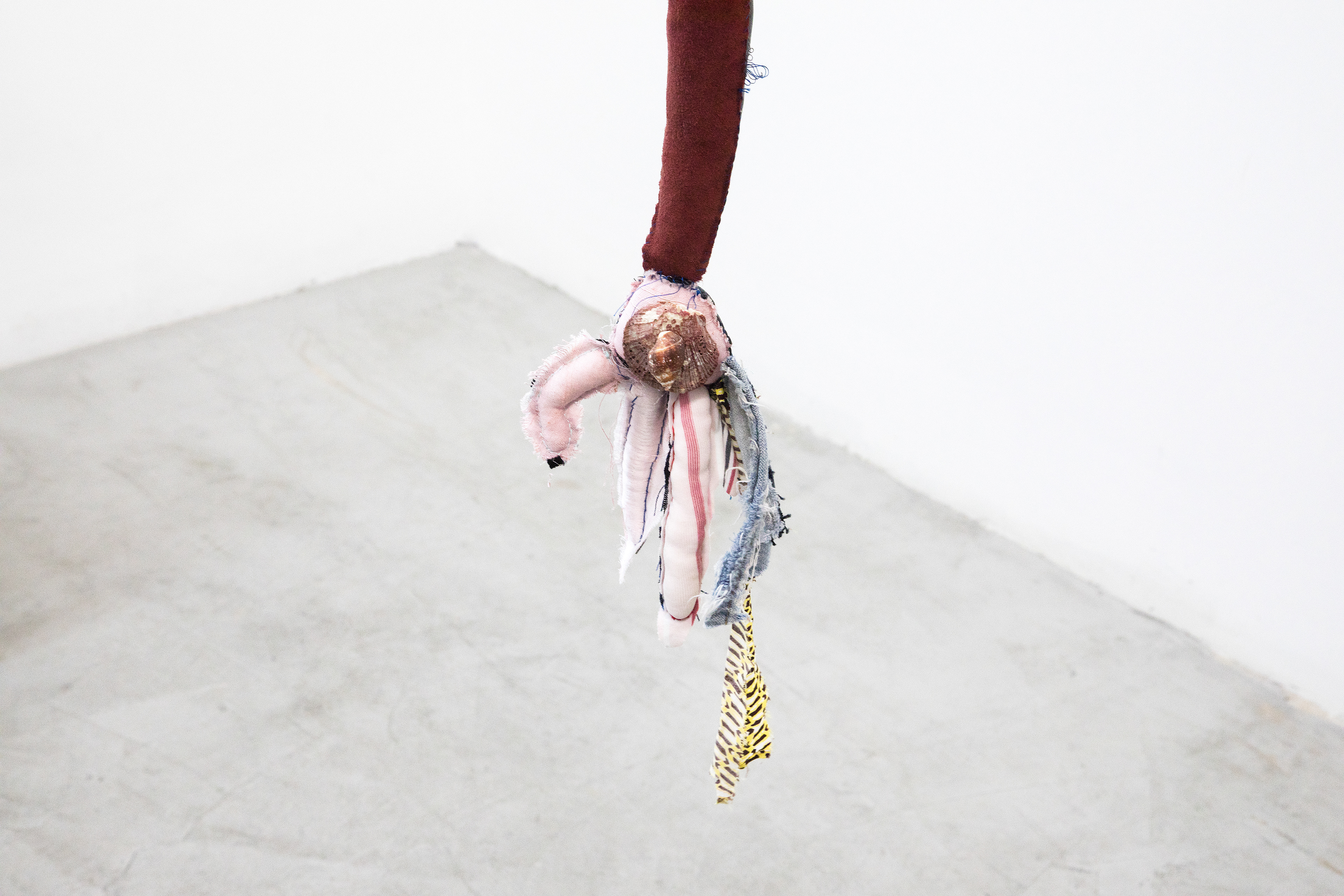 the first breath we took together as one negro fish, 2018. Fabric, leather, lantern, seashells, acrylic paint, stones, human hair, jute. Dimensions variable.