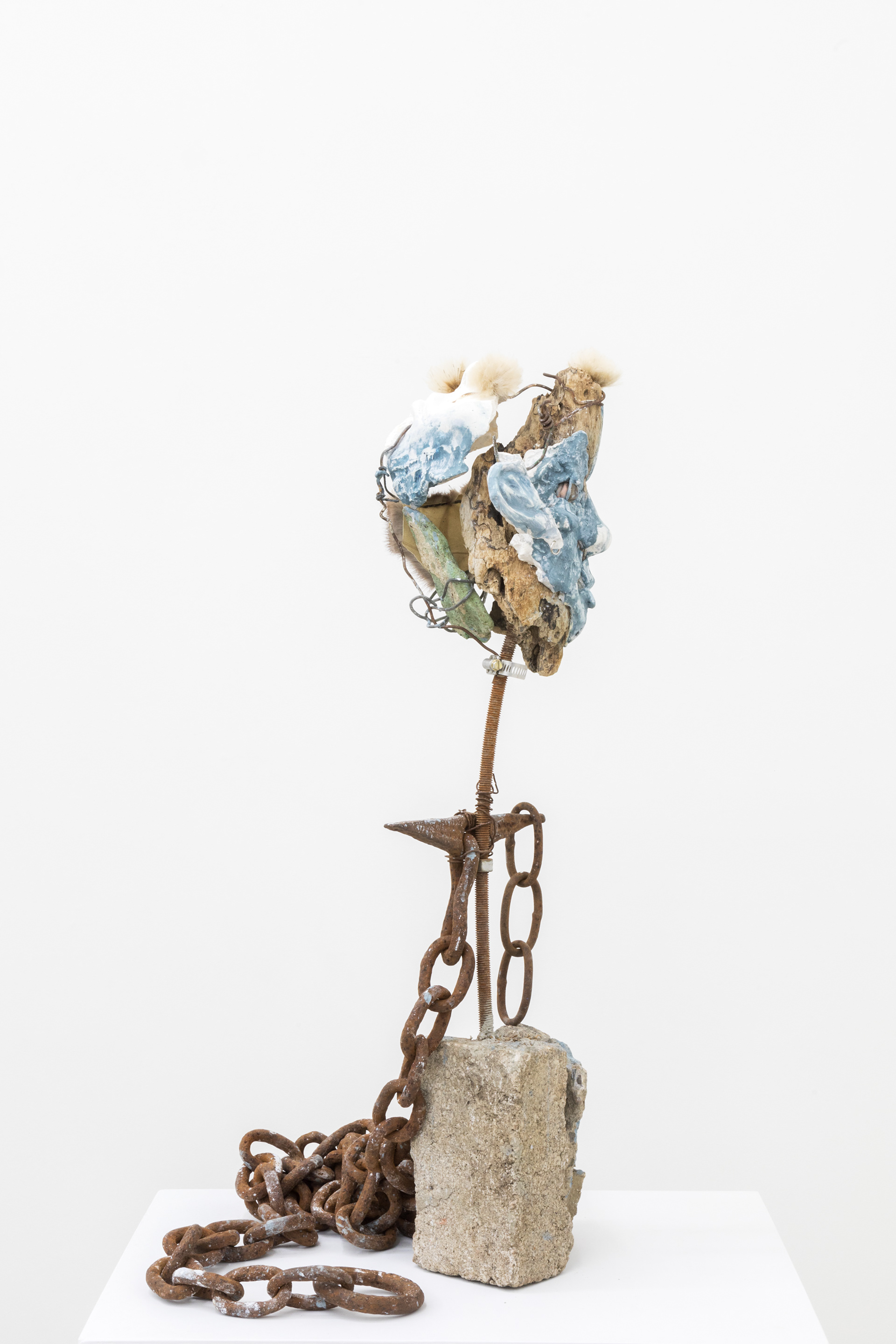 Big tooth (angels in a sleepy current), 2017. Hand carved plaster, stones, wire, acrylic paint, fur, milk thistle seeds, earring, driftwood, rebar, chain, concrete.