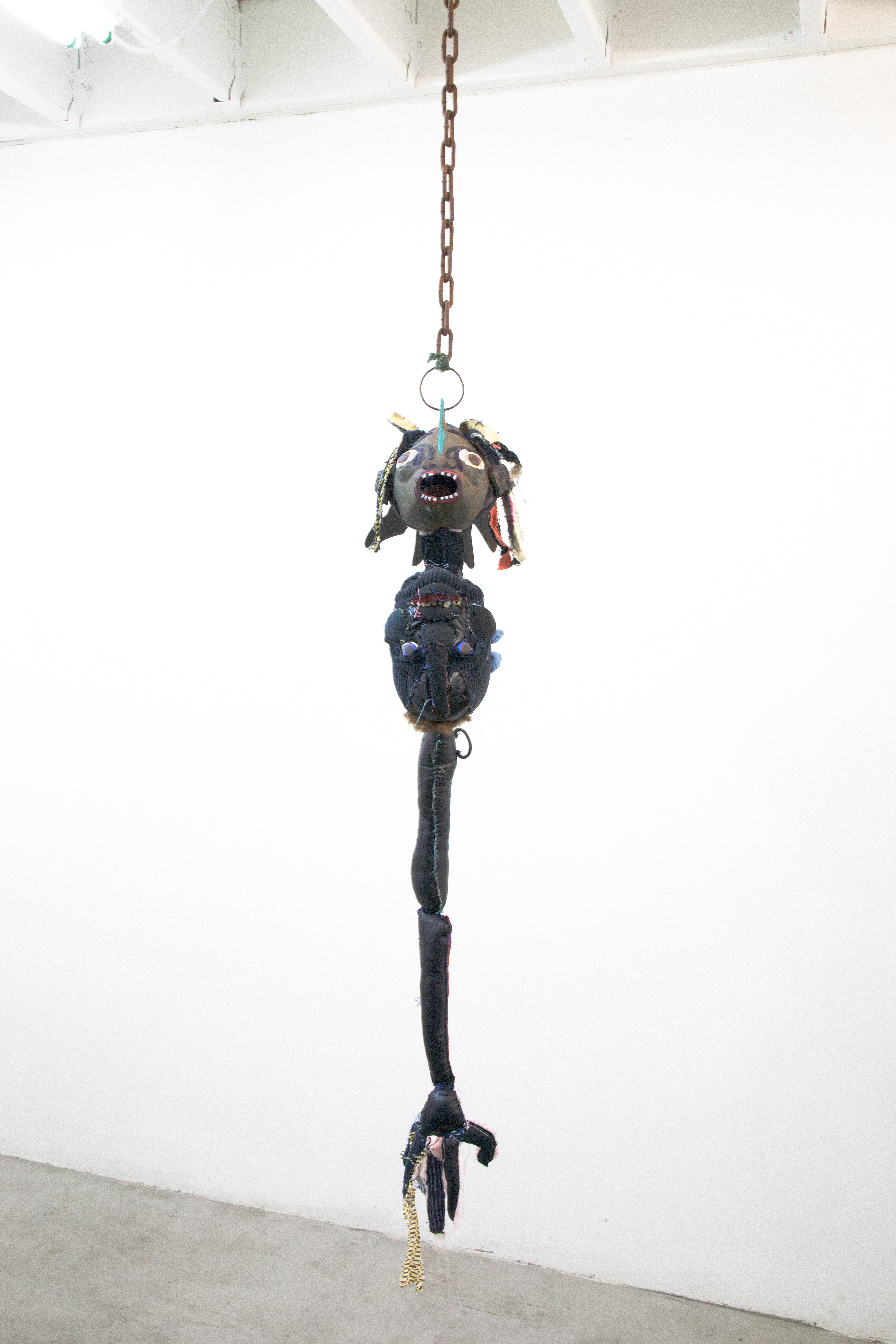 the first breath we took together as one negro fish, 2018. Fabric, leather, lantern, seashells, acrylic paint, stones, human hair, jute. Dimensions variable.