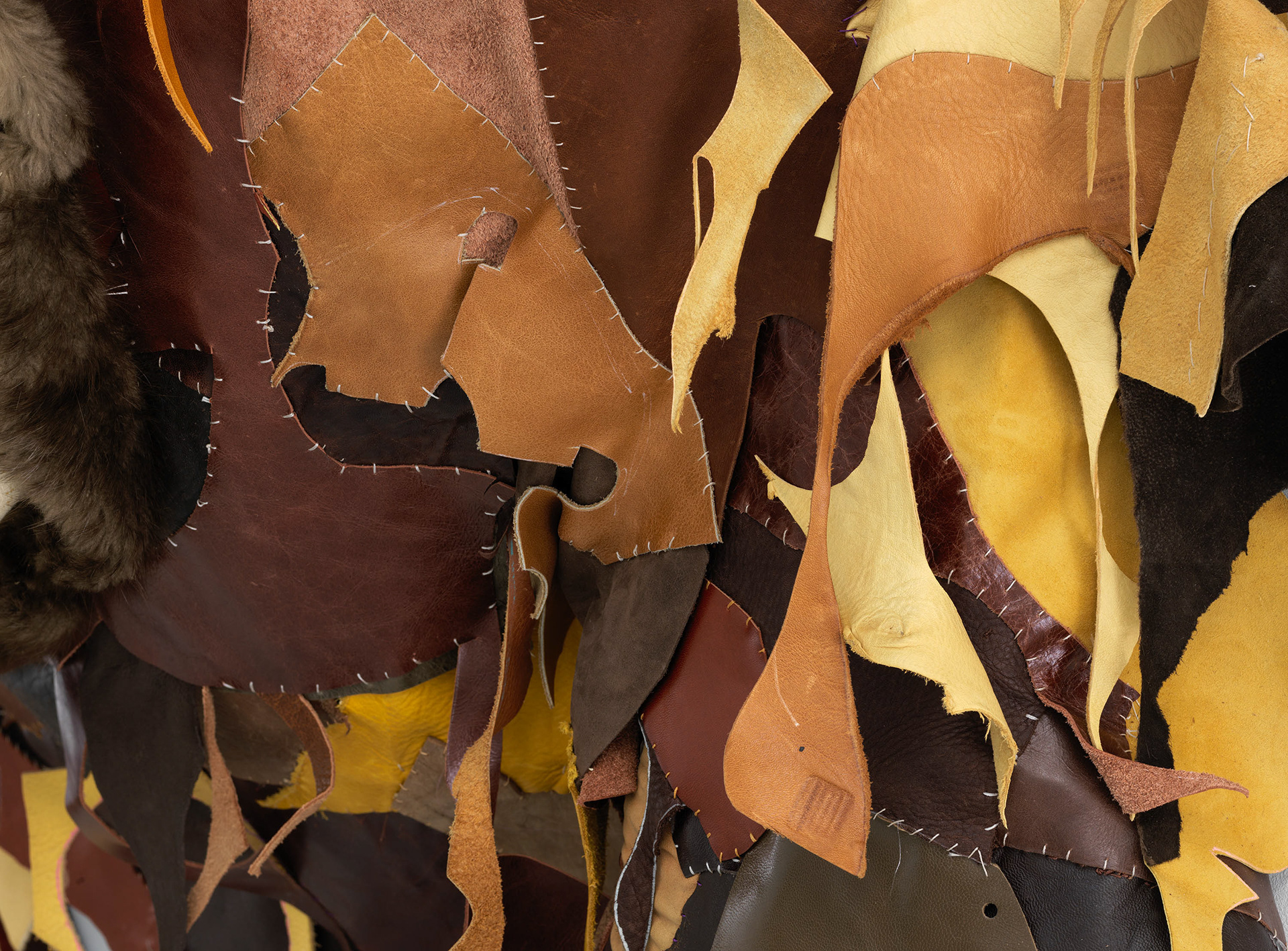(detail) Mater Dei, 2022, Steel, enamel paint, repurposed leather, fur, shearling, suede, tortoise shell, rawhide, organic cotton twill, and coated nylon thread, 134 x 113 3/8 x 31 inches