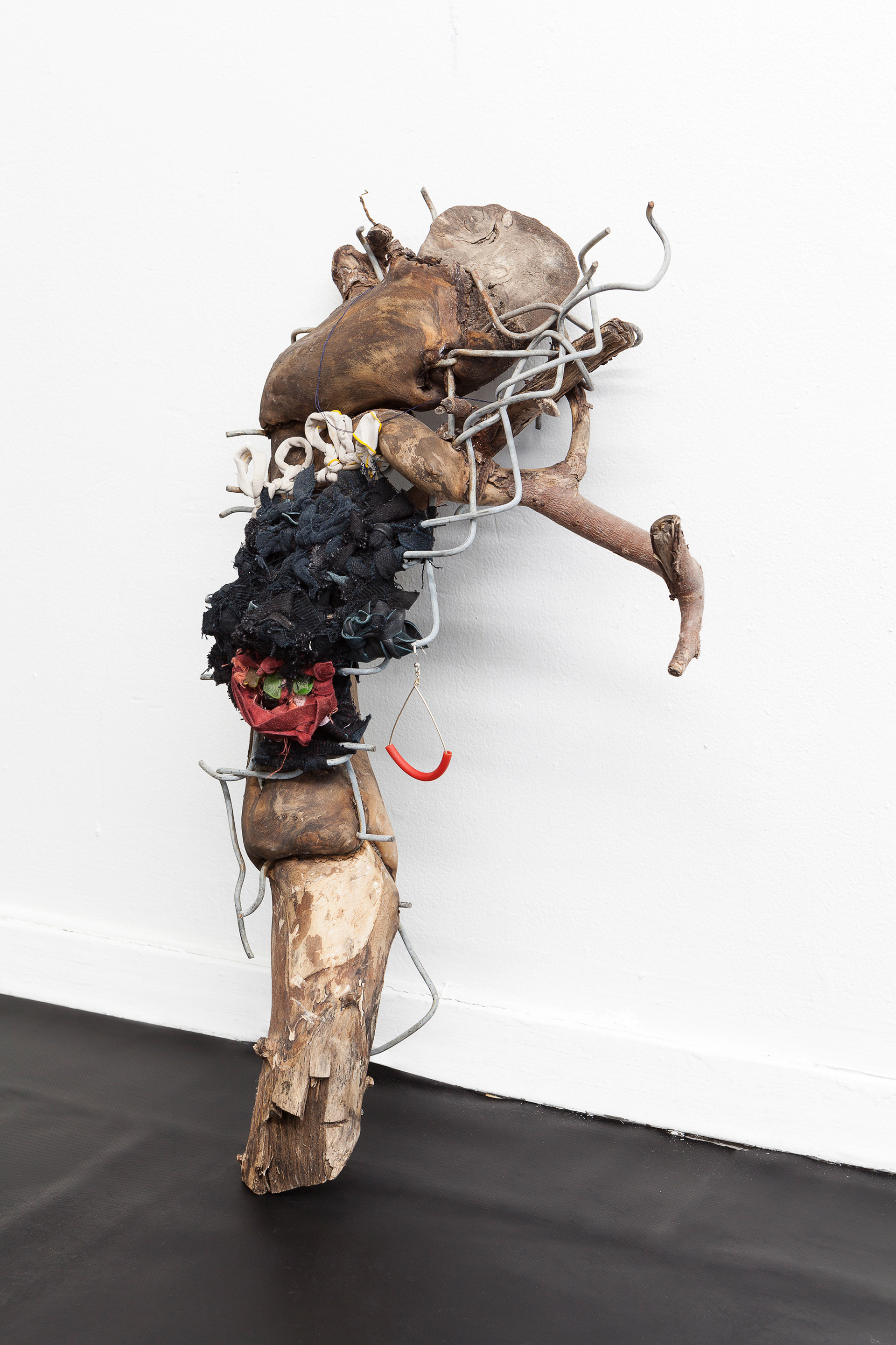 Knotty, 2018. Wood, fence, leather, fabric, sea glass, tar, earring. 18 x 12 x 6 in (45.7 x 30.5 x 15.2 cm).