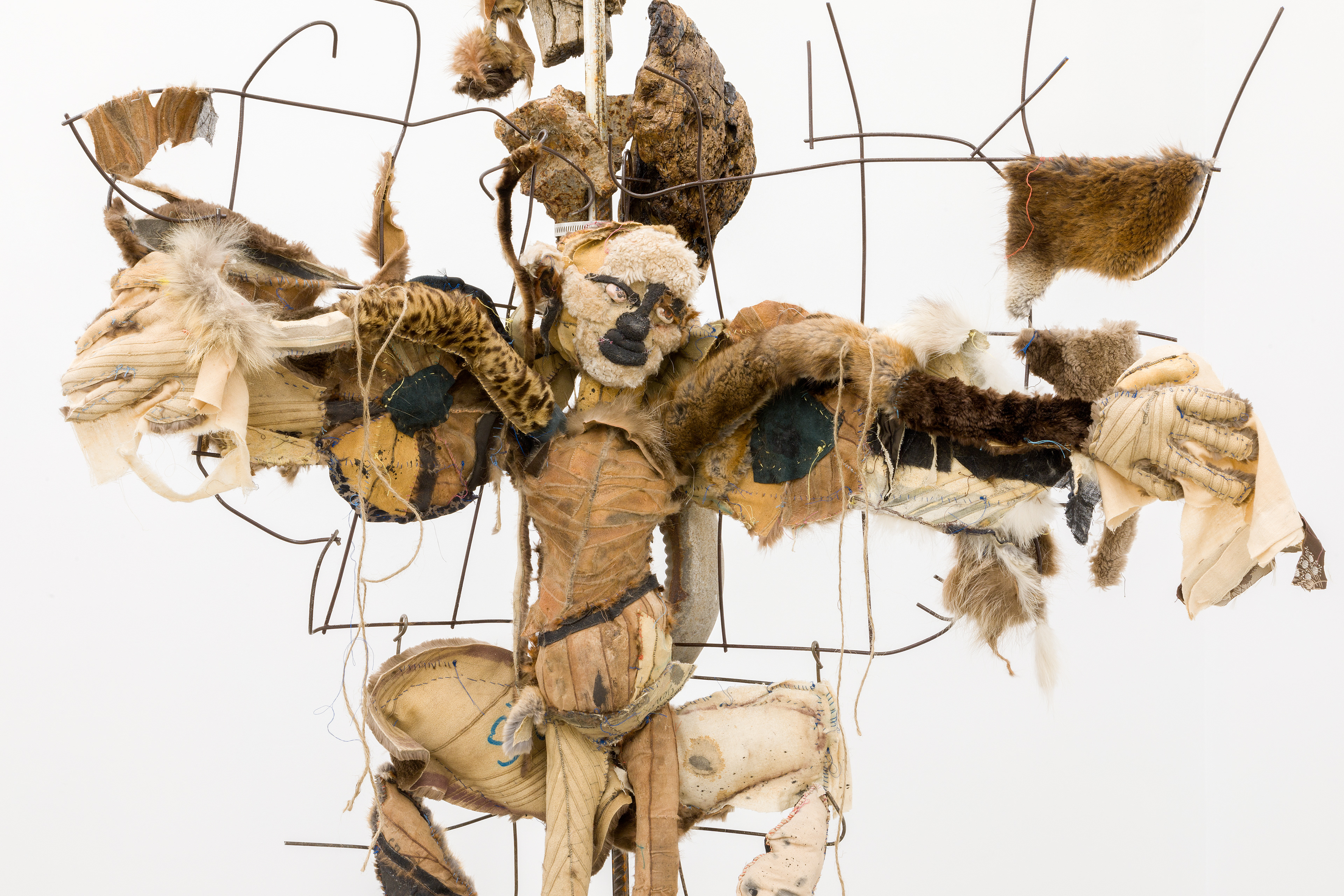 Three angels waiting, 2018. Concrete, rebar, concrete mesh, hand sewn furs, leathers and fabrics, cotton batting, stones, pipes, driftwood, dried flowers, hardware. 76 x 38 x 24 inches (193.04 x 96.52 x 60.96 cm).
