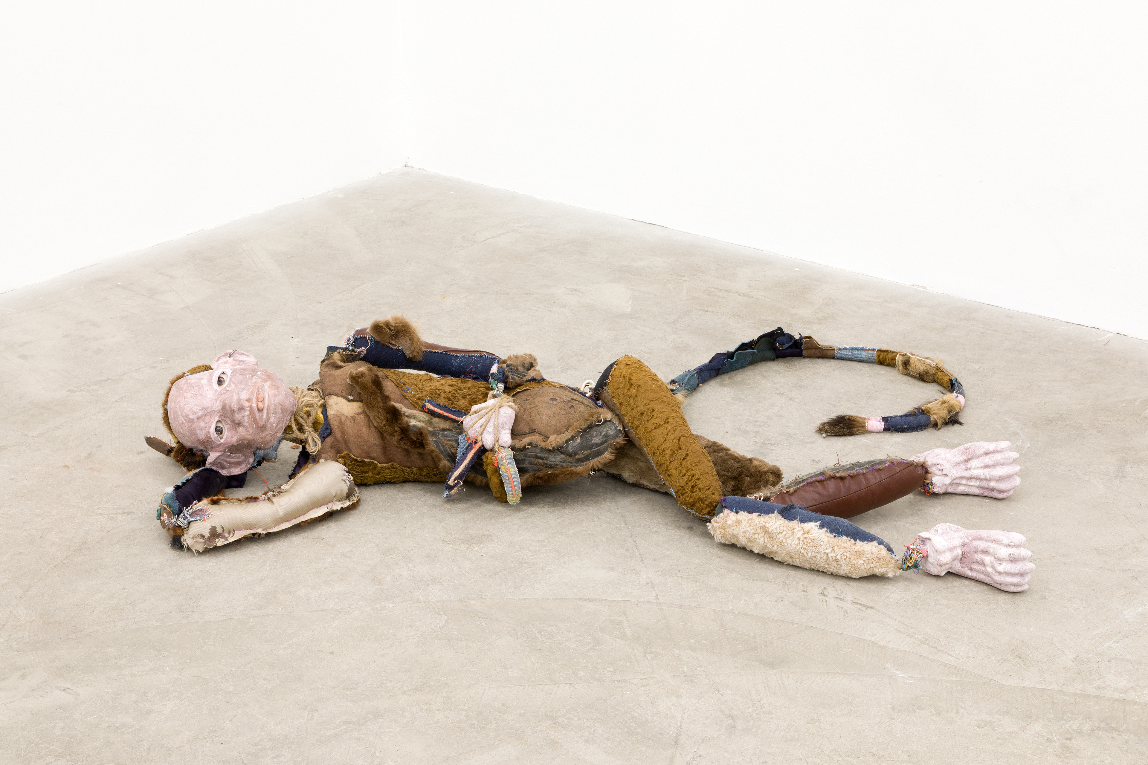 Earnest Lewis King 2017-2018. Hand carved plaster, acrylic paint, hand sewn fabric, leather, fur, jute, paint can, wire, hardware, stones, seashells, chalk pastel, human hair, cotton batting, polyester bating. 10 x 70 x 18 in (25.4 x 177.8 x 45.7 cm).