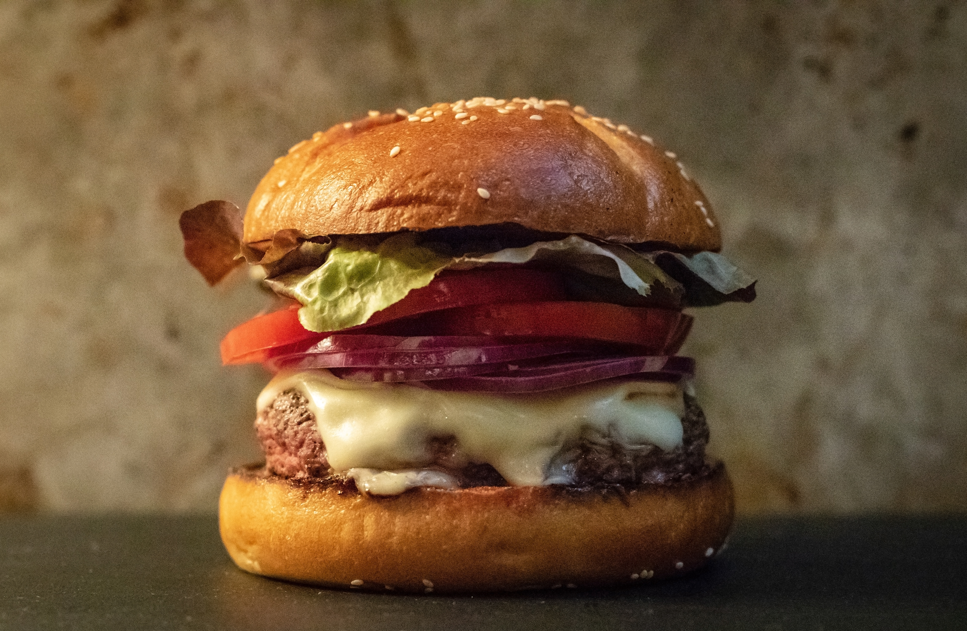 bison burger with american cheese, lettuce, tomato, onions, and pickles