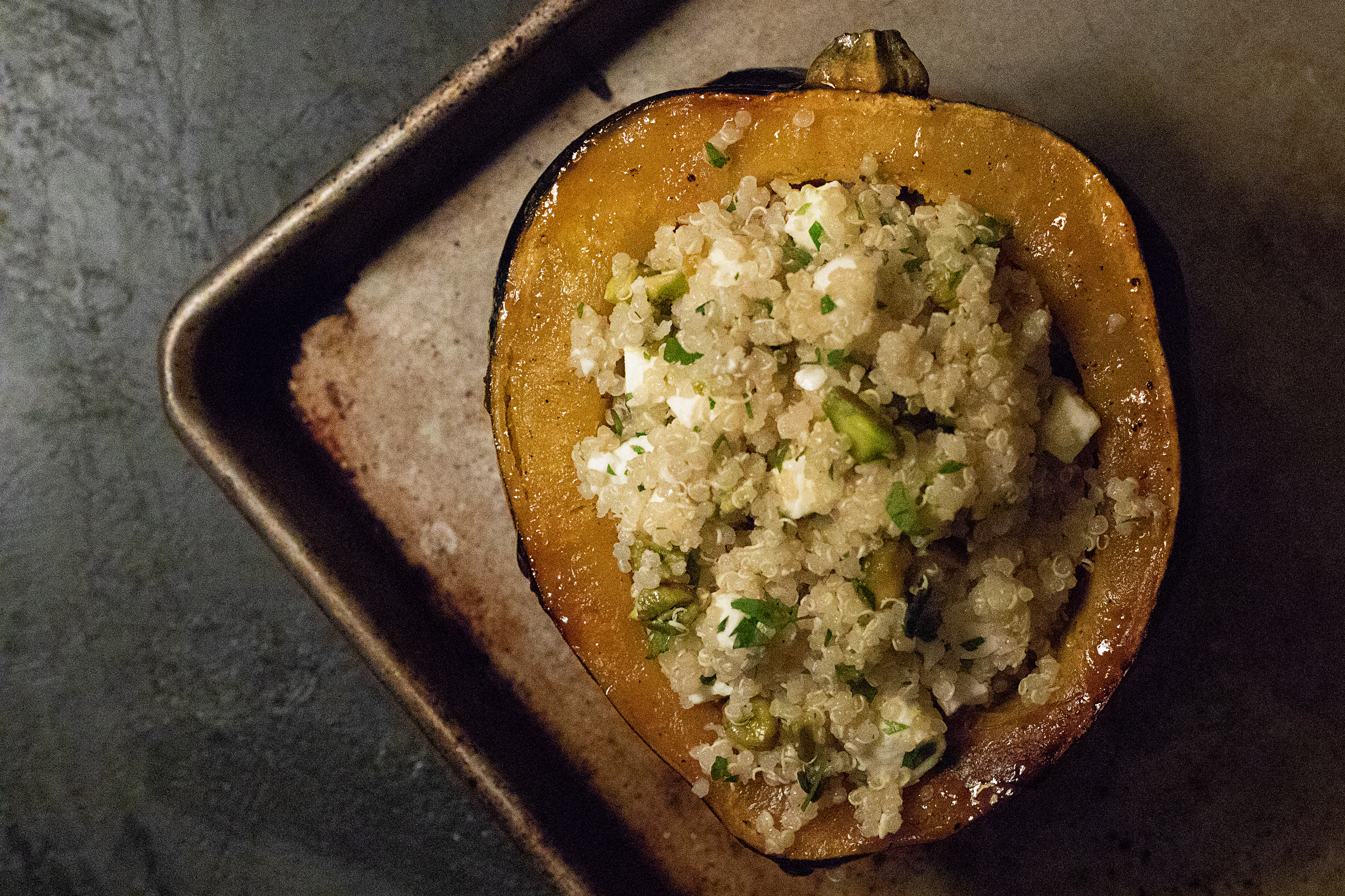 roasted acorn squash stuffed with quinoa, feta, and pistachios