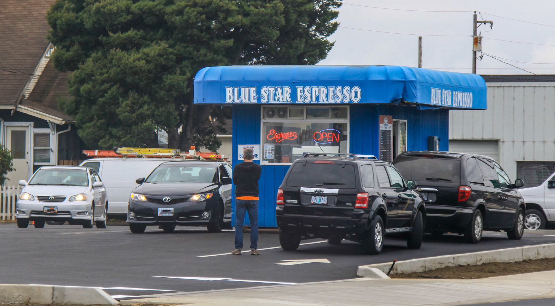 Man standing in line in the drive-thru of a coffee shop
