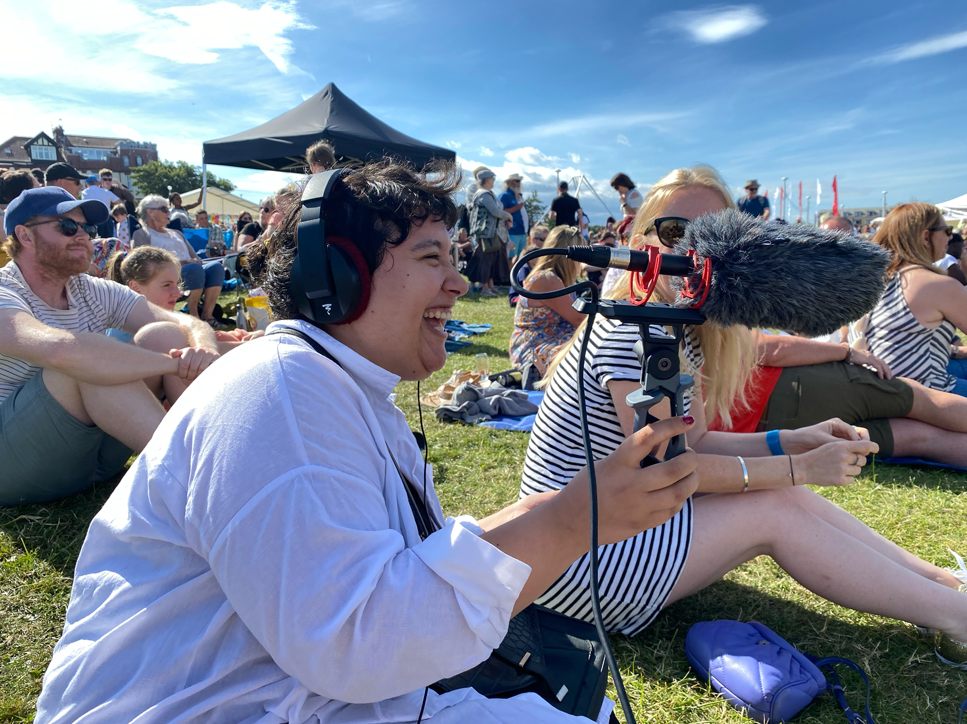 Lily Daniels recording with a shotgun microphone at the Summer Streets Festival 2022