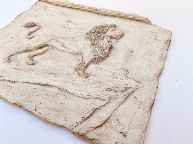Tile was first sculpted with Plastiline before moulded in silicone and cast using Jesmonite 730.  Finally a brown acrylic wash for ageing detail.