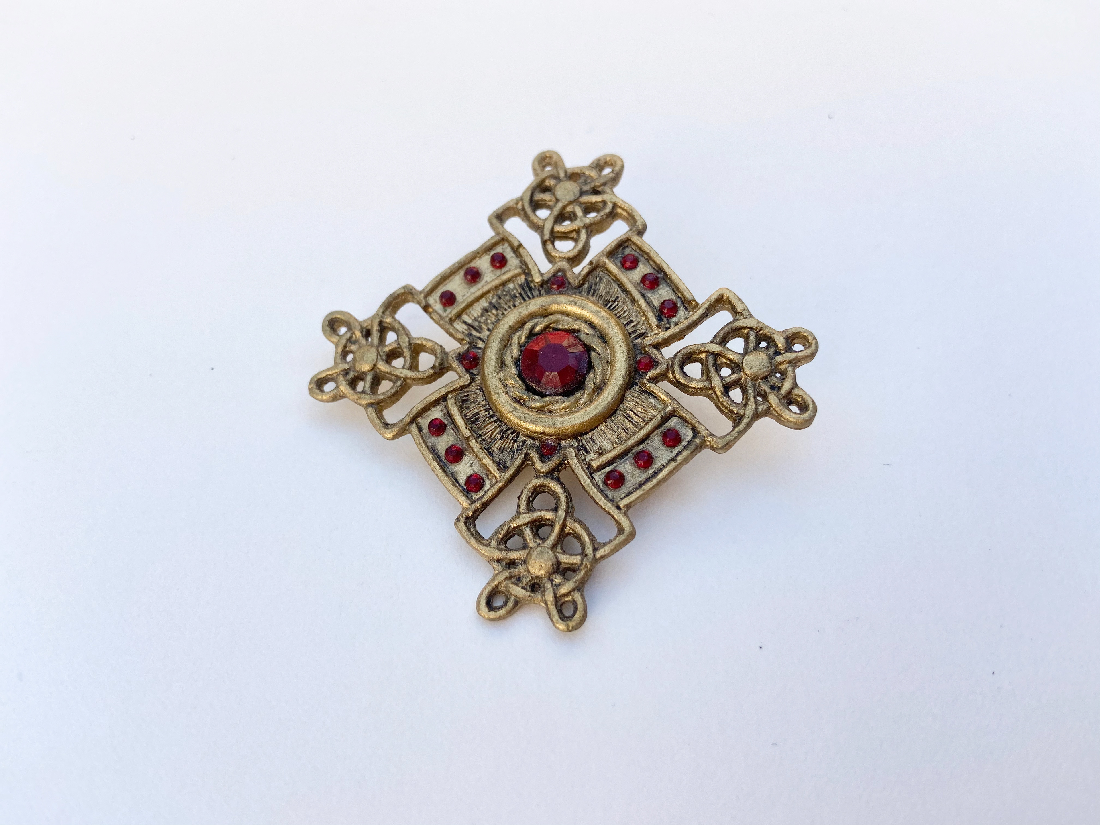 Medieval jewellery first sculpted from Plastiline before moulded in silicone and cast from Polyurethane fast cast resin.  Painted with gold acrylic paint with a brown acrylic wash for ageing detail.  Red gemstones added last.