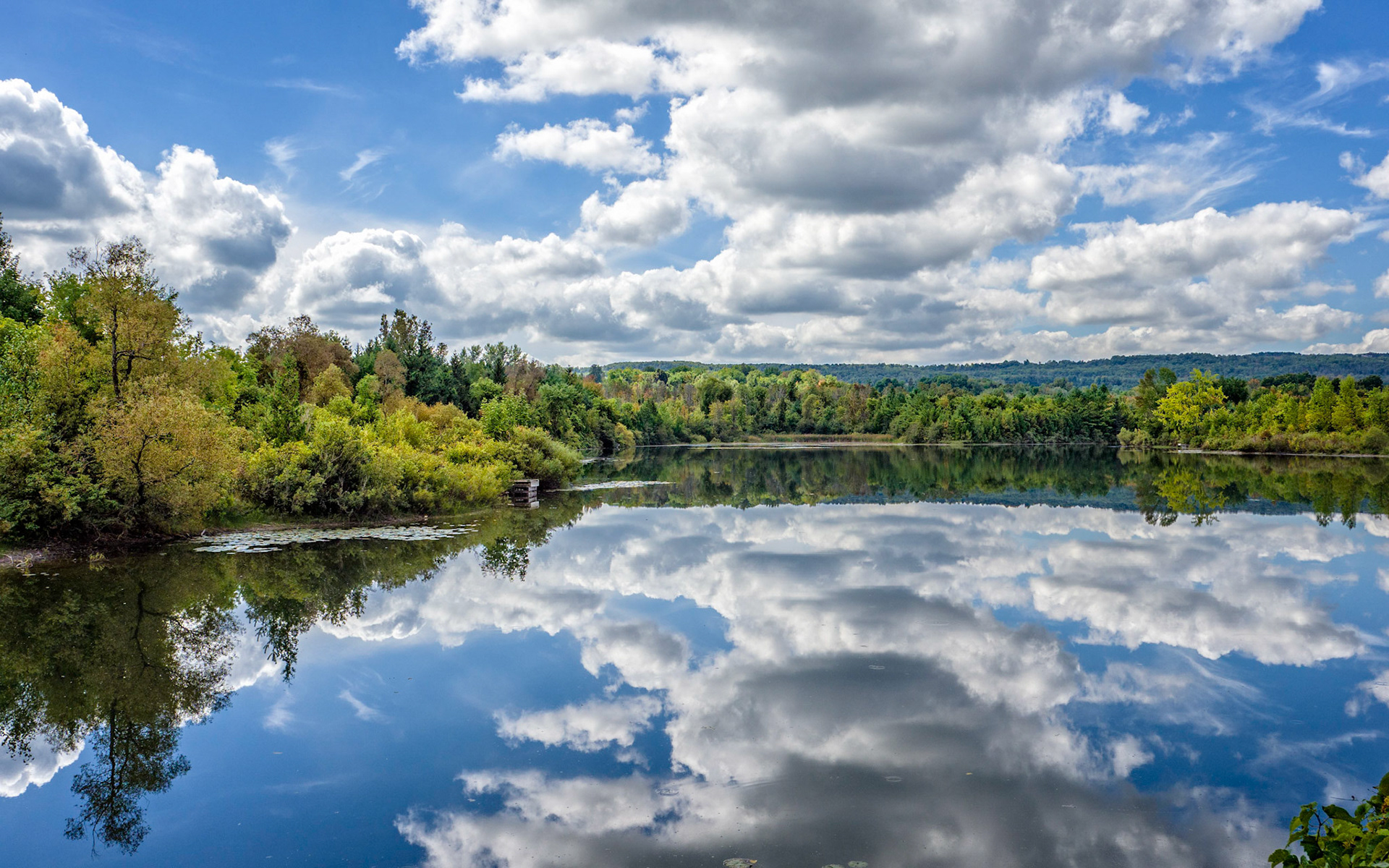 Clouds perfectly reflected in the Clendennan Dam reservoir, Clarksburg, Ontario.