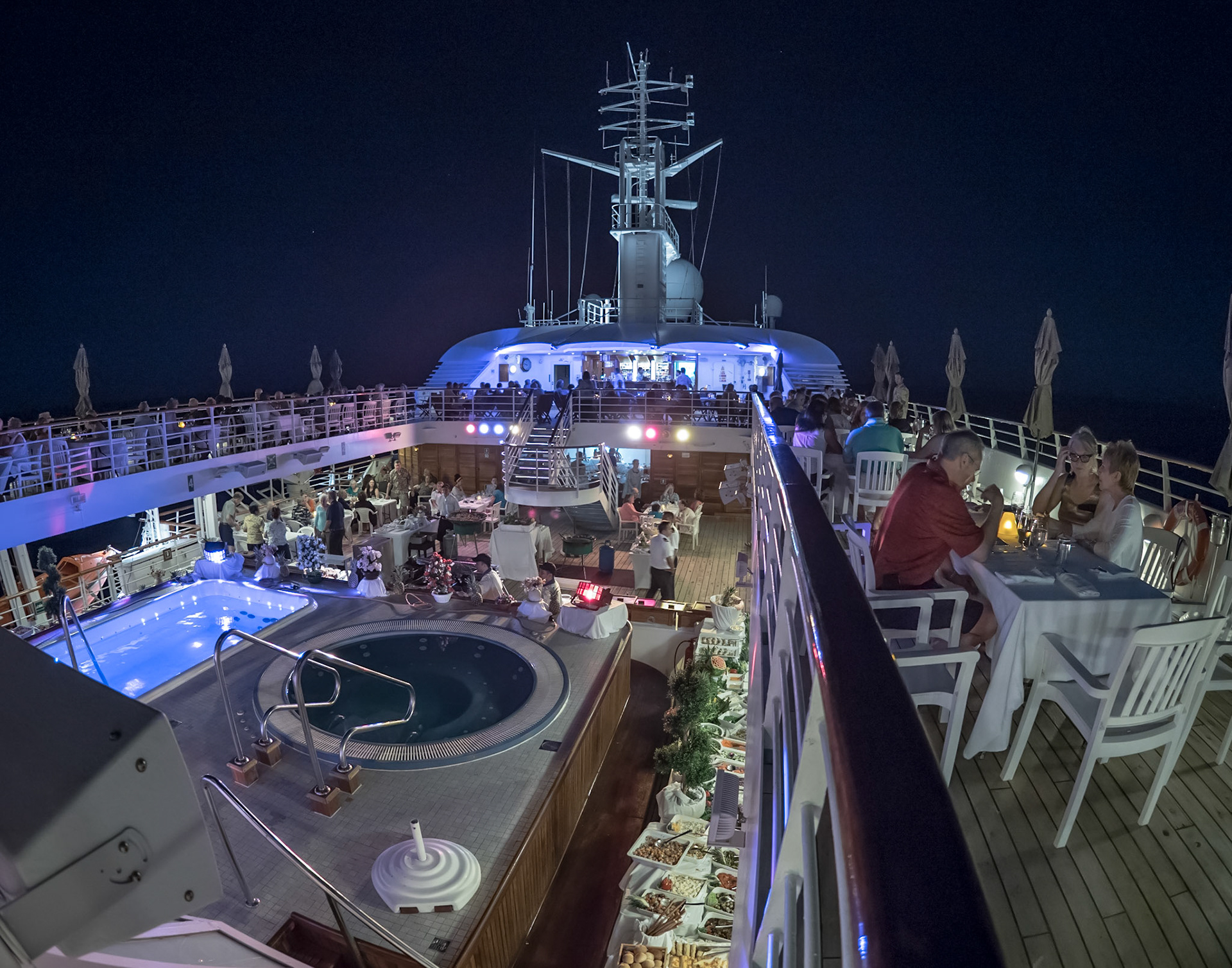A Panama cruise ship full of passengers enjoying an evening party on deck.