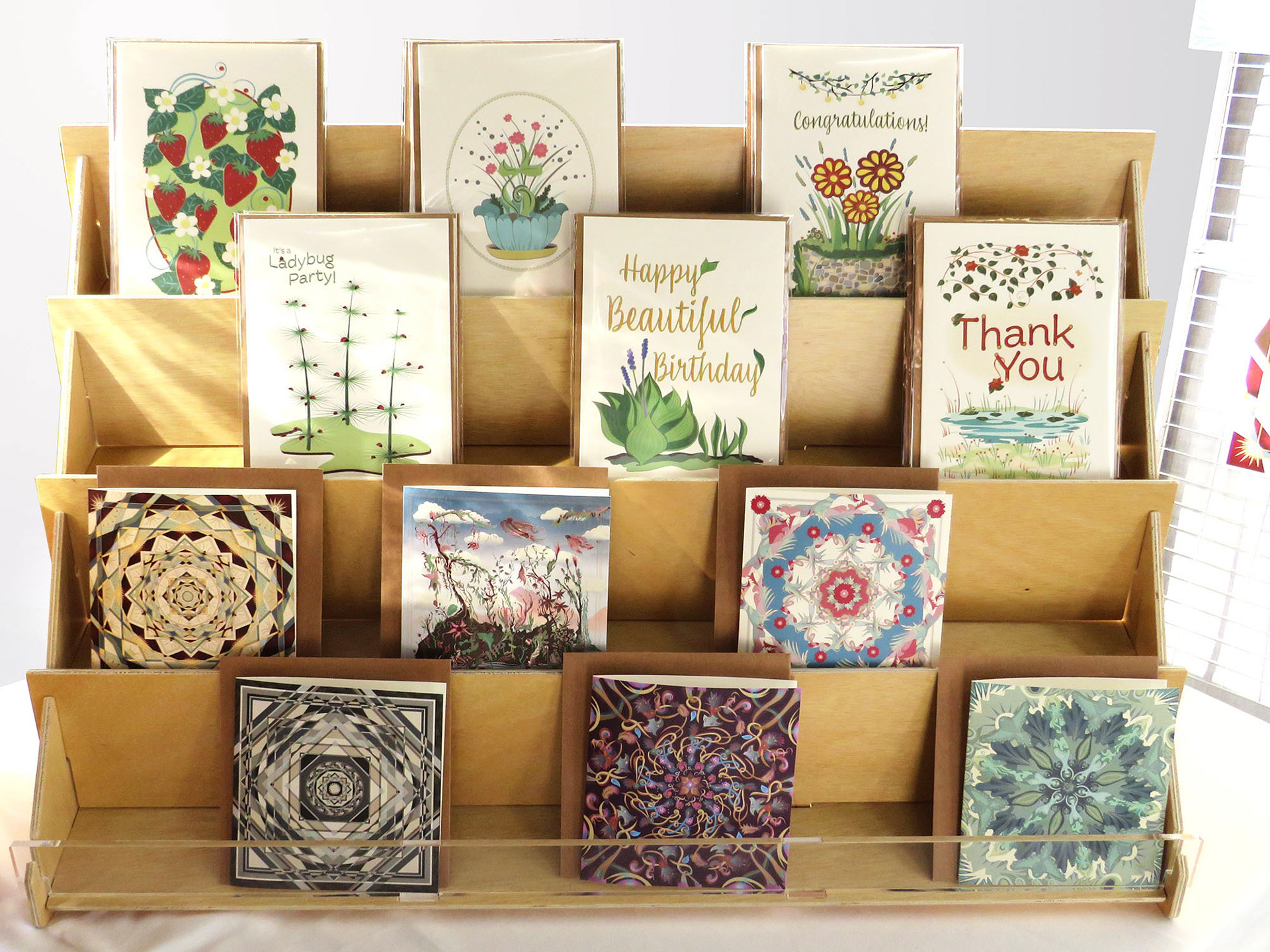 Greeting Card display rack with floral designed cards.