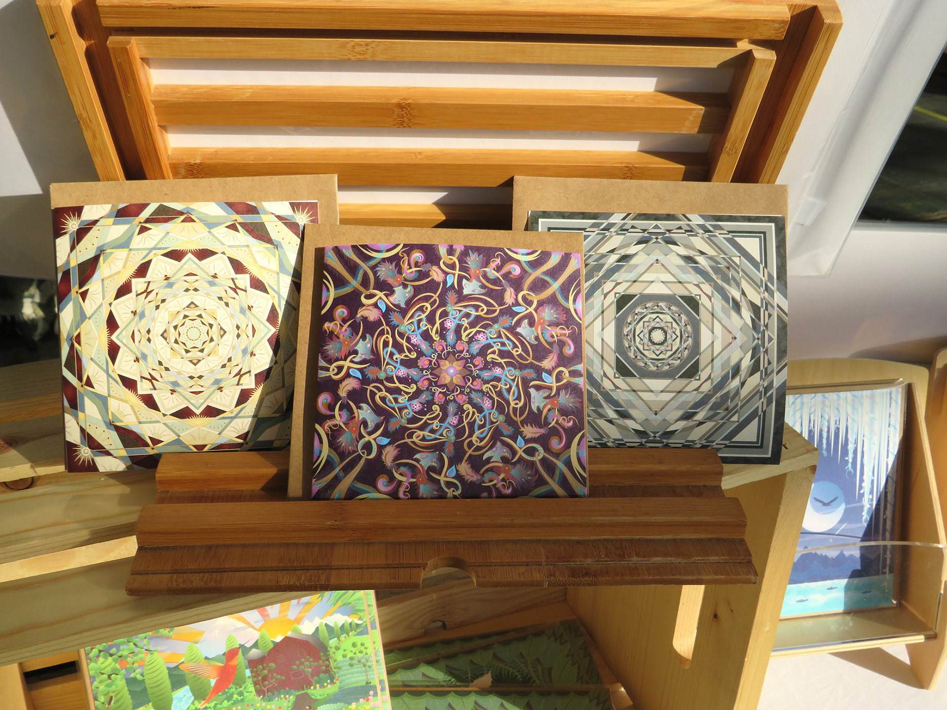 Greeting Card display rack with mandala designs on cards.