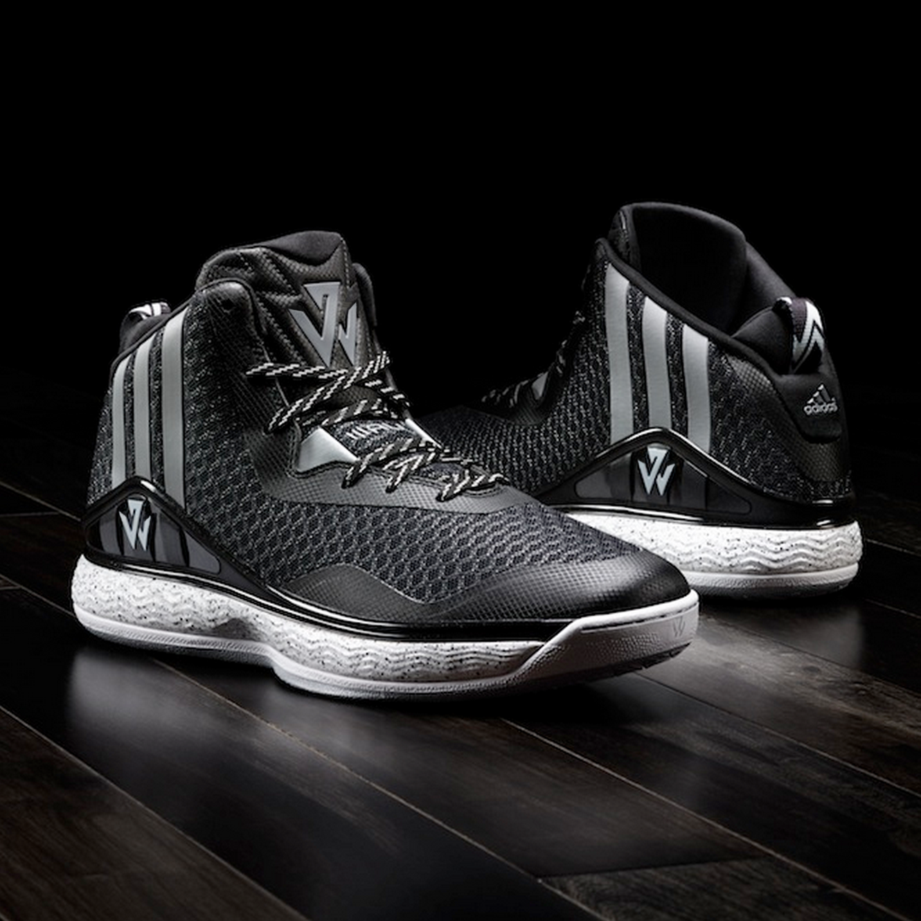 Image of footwear J-Wall 1 in black and gray toting the new logo on the tong and side.
